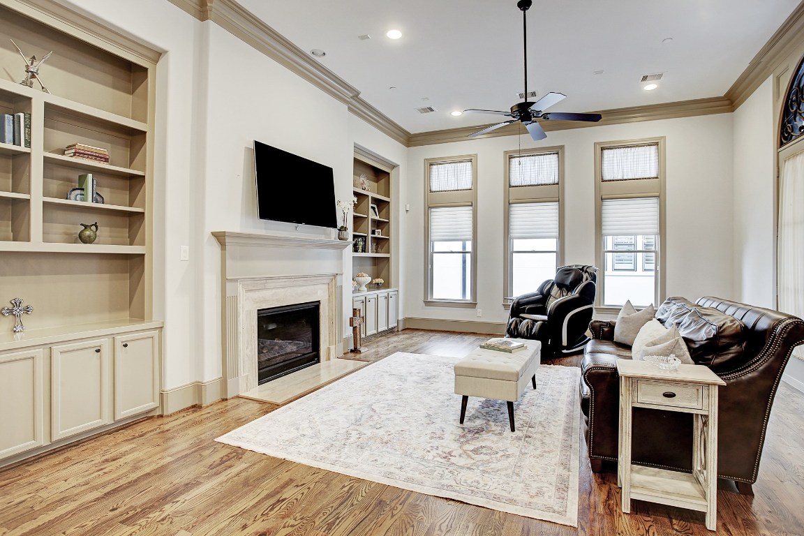 1307 Rosedale Street Houston, TX 77004 - Photo 12 of 32 The living area is filled with natural light. Beautifully crafted built-ins flank the gaslog fireplace.