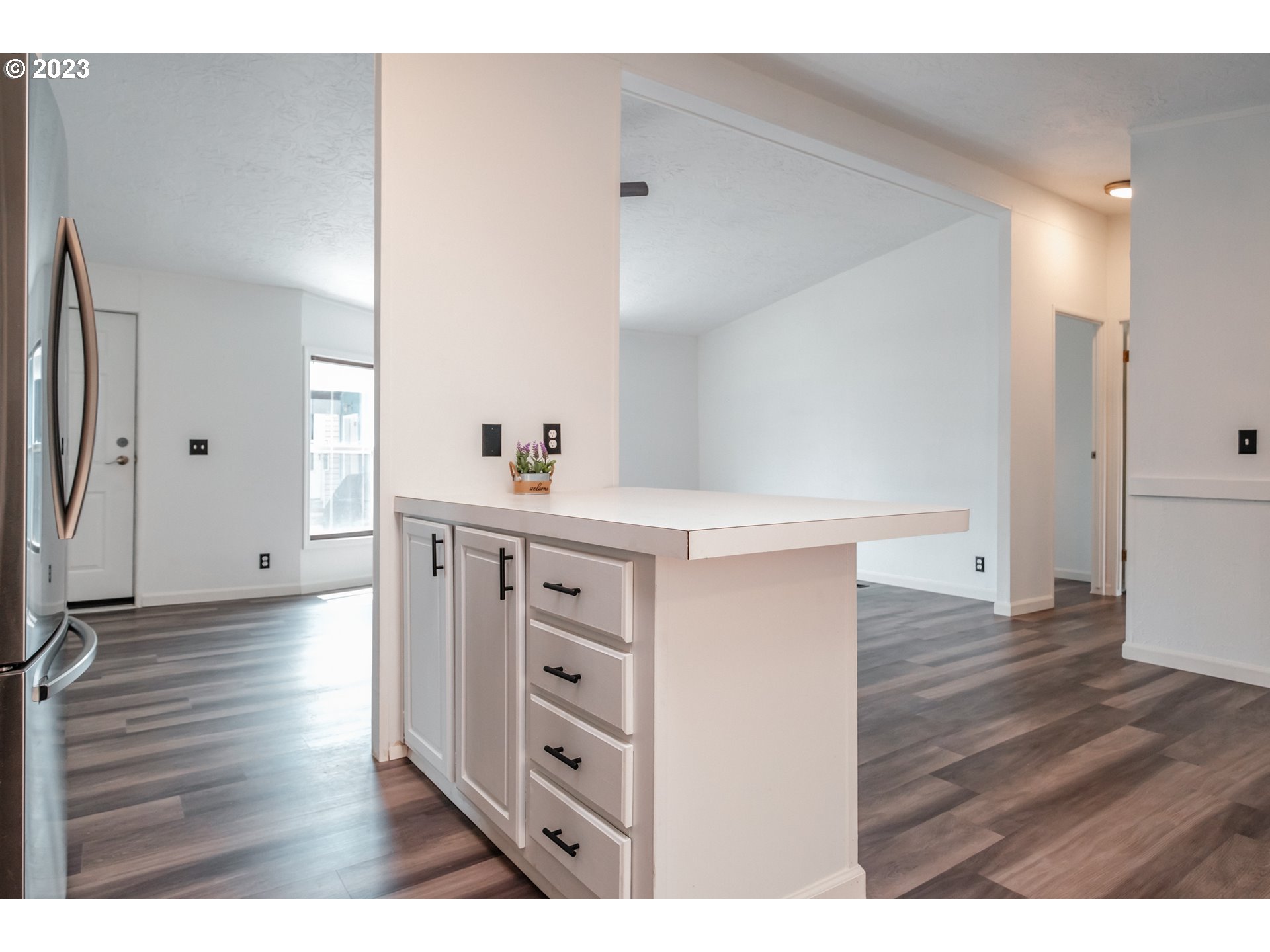 1401 West Ellendale Avenue, Unit 80 Dallas, OR 97338 - Photo 20 of 48 a hall with cabinets and wooden floor