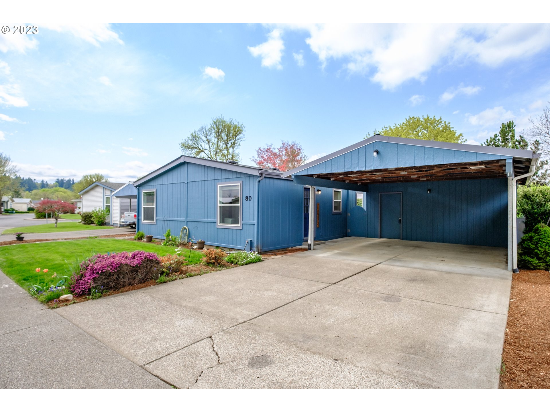 1401 West Ellendale Avenue, Unit 80 Dallas, OR 97338 - Photo 2 of 48 a front view of a house with a yard and garage