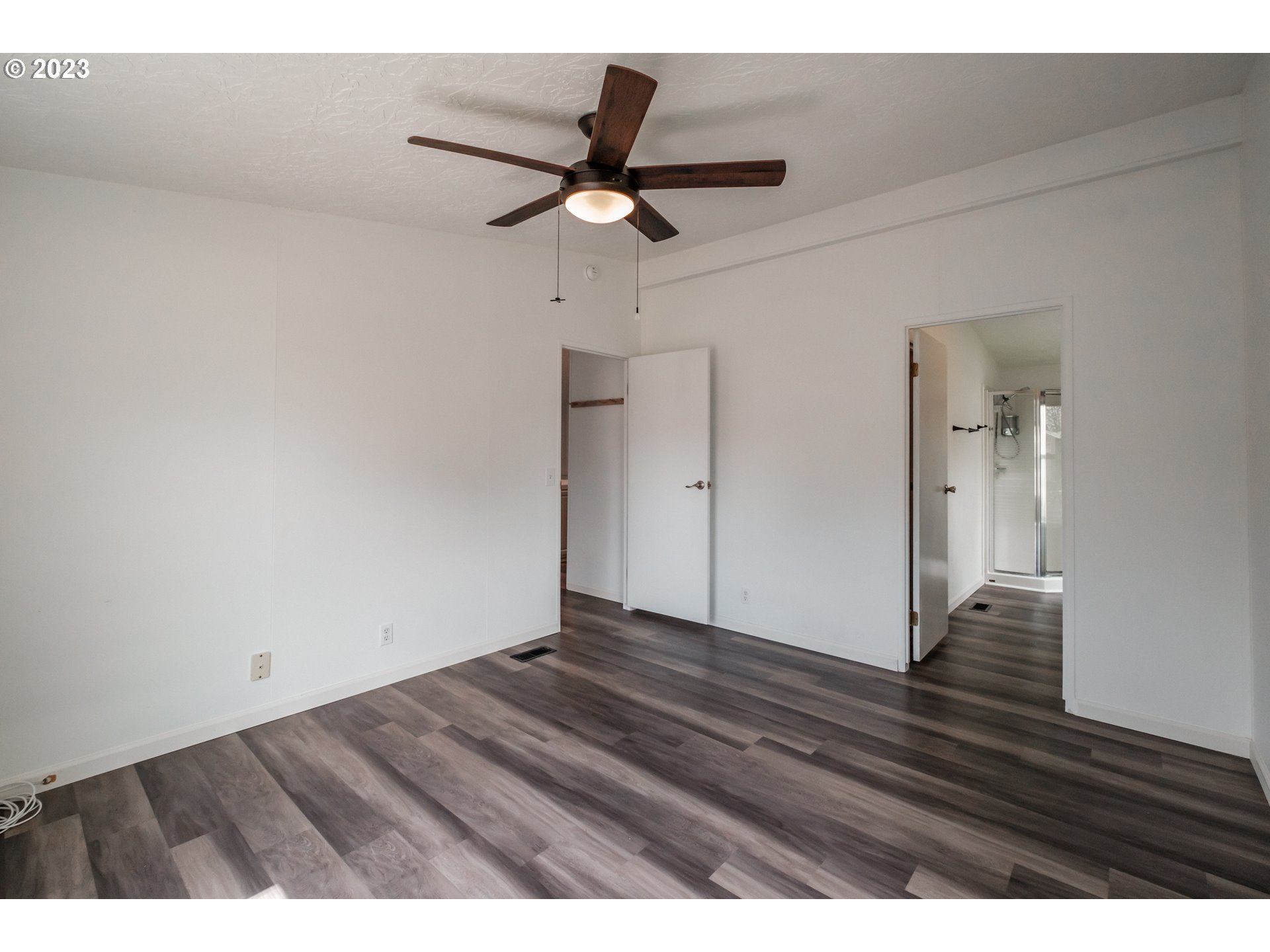 1401 West Ellendale Avenue, Unit 80 Dallas, OR 97338 - Photo 24 of 48 a view of an empty room and wooden floor