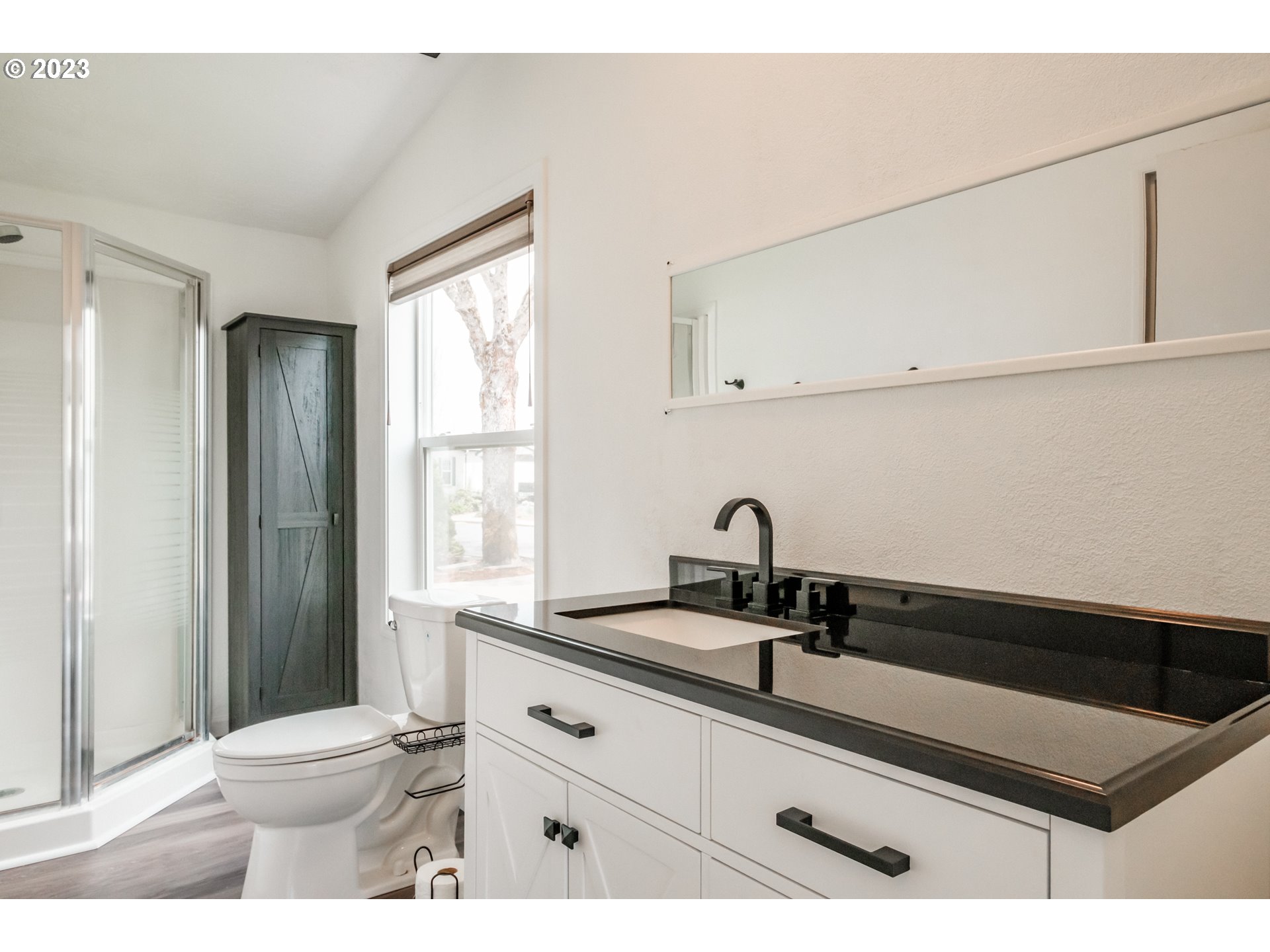 1401 West Ellendale Avenue, Unit 80 Dallas, OR 97338 - Photo 27 of 48 a bathroom with a sink a toilet and a window