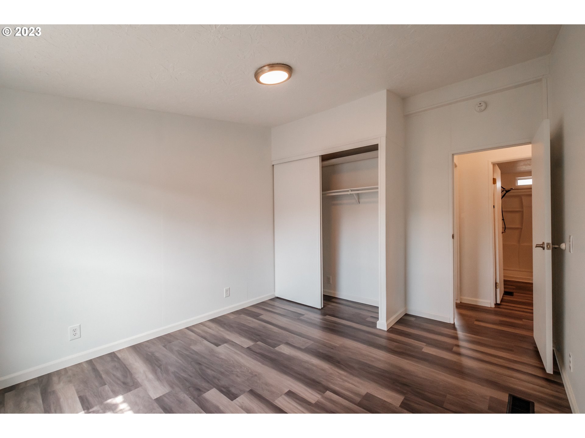 1401 West Ellendale Avenue, Unit 80 Dallas, OR 97338 - Photo 29 of 48 a view of an empty room with wooden floor
