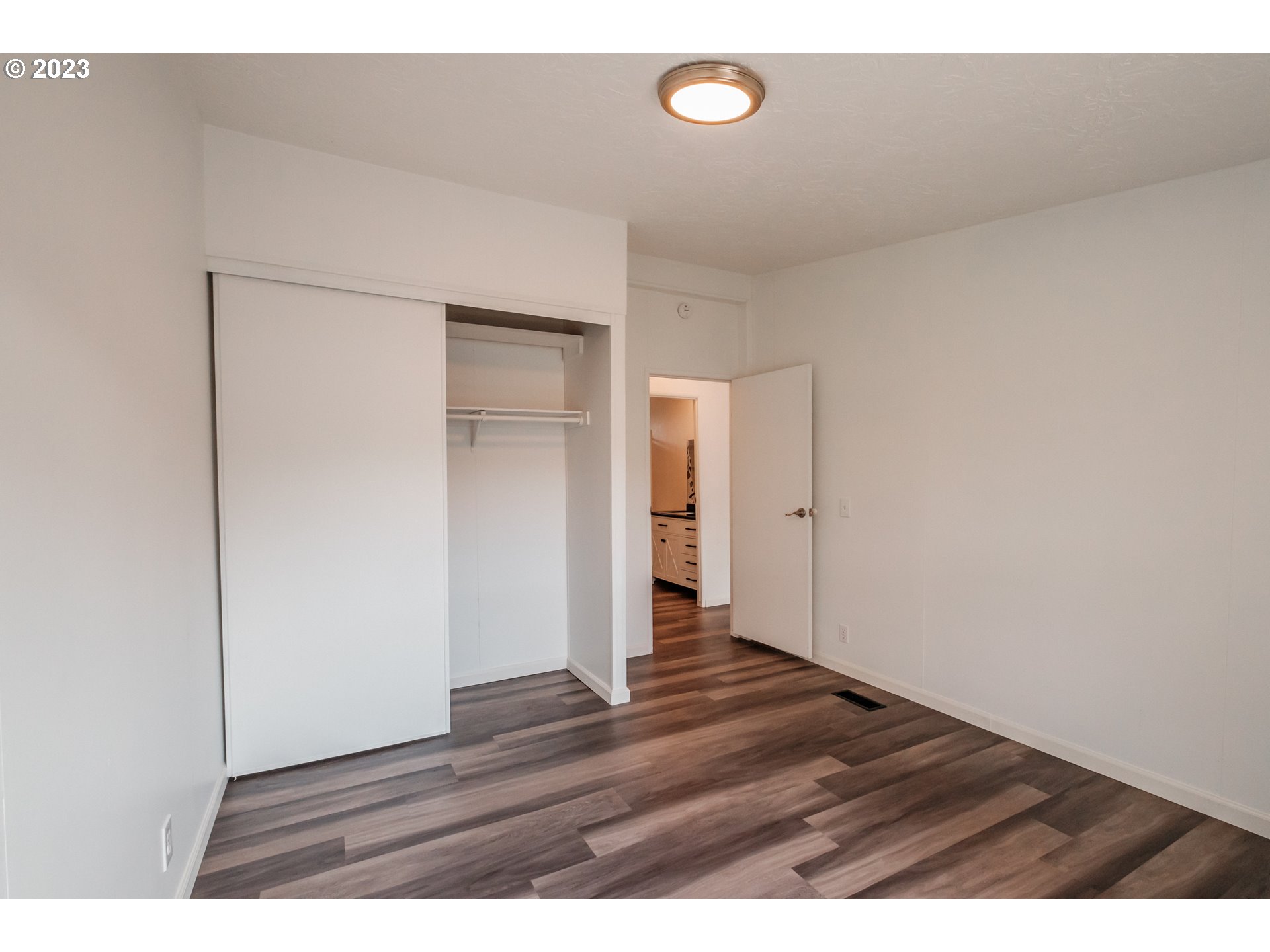 1401 West Ellendale Avenue, Unit 80 Dallas, OR 97338 - Photo 31 of 48 an empty room with wooden floor