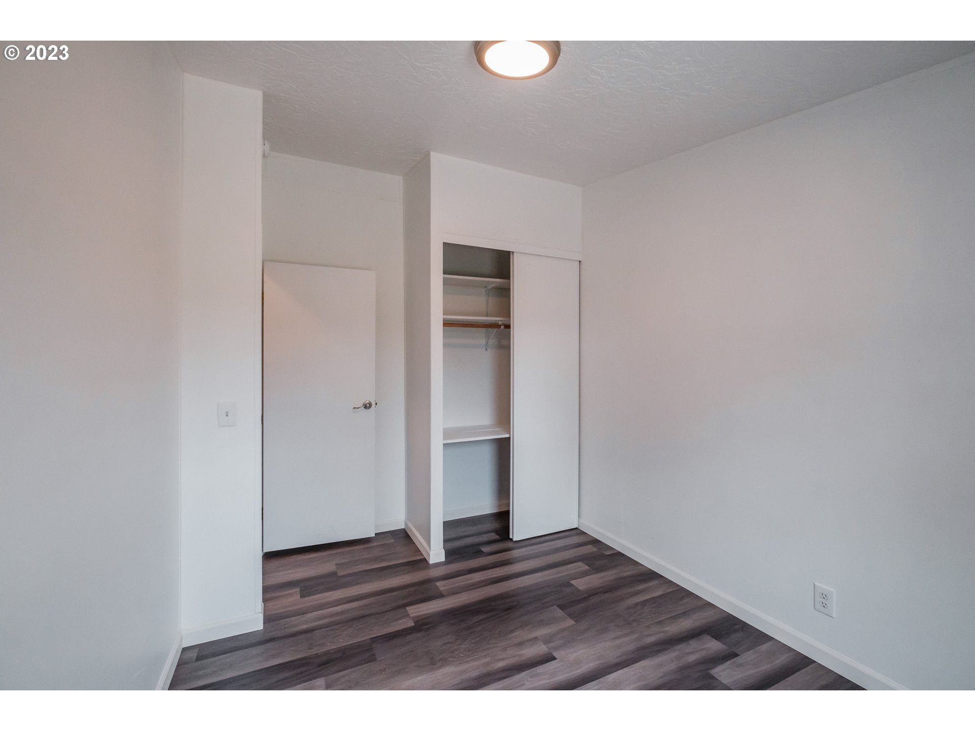 1401 West Ellendale Avenue, Unit 80 Dallas, OR 97338 - Photo 35 of 48 a view of an empty room with wooden floor