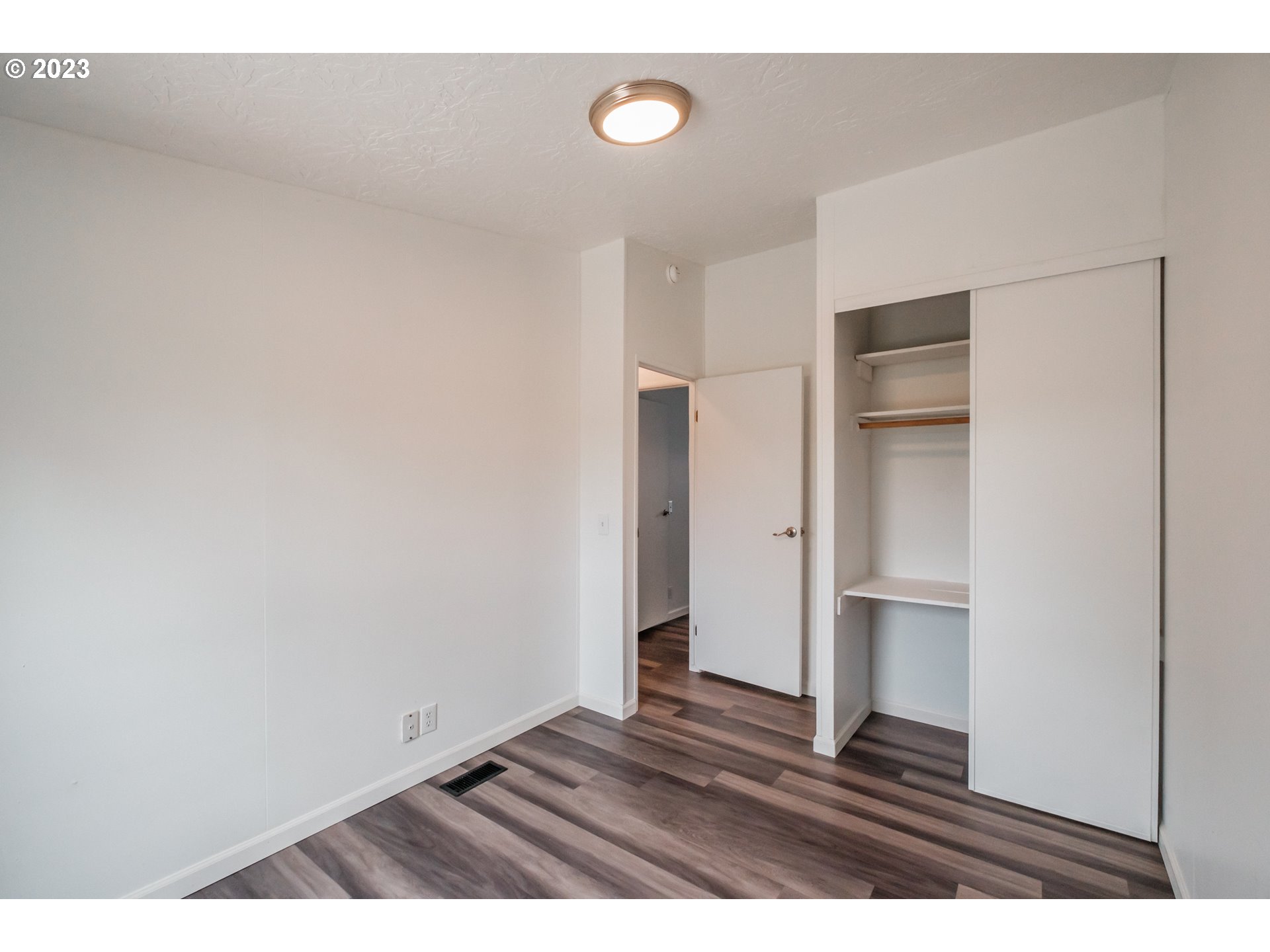 1401 West Ellendale Avenue, Unit 80 Dallas, OR 97338 - Photo 36 of 48 a view of an empty room and wooden floor