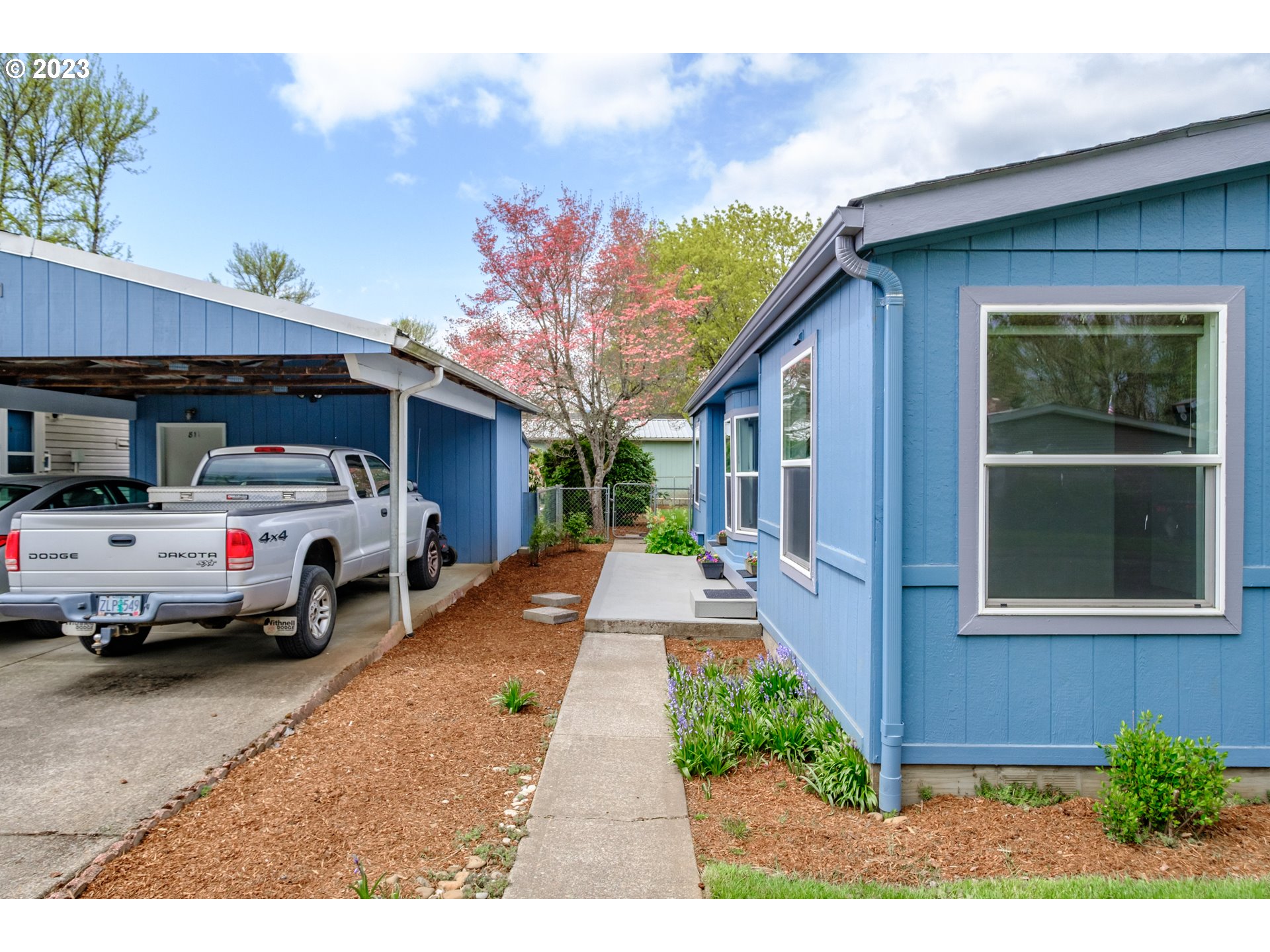 1401 West Ellendale Avenue, Unit 80 Dallas, OR 97338 - Photo 4 of 48 a front view of a house with garden