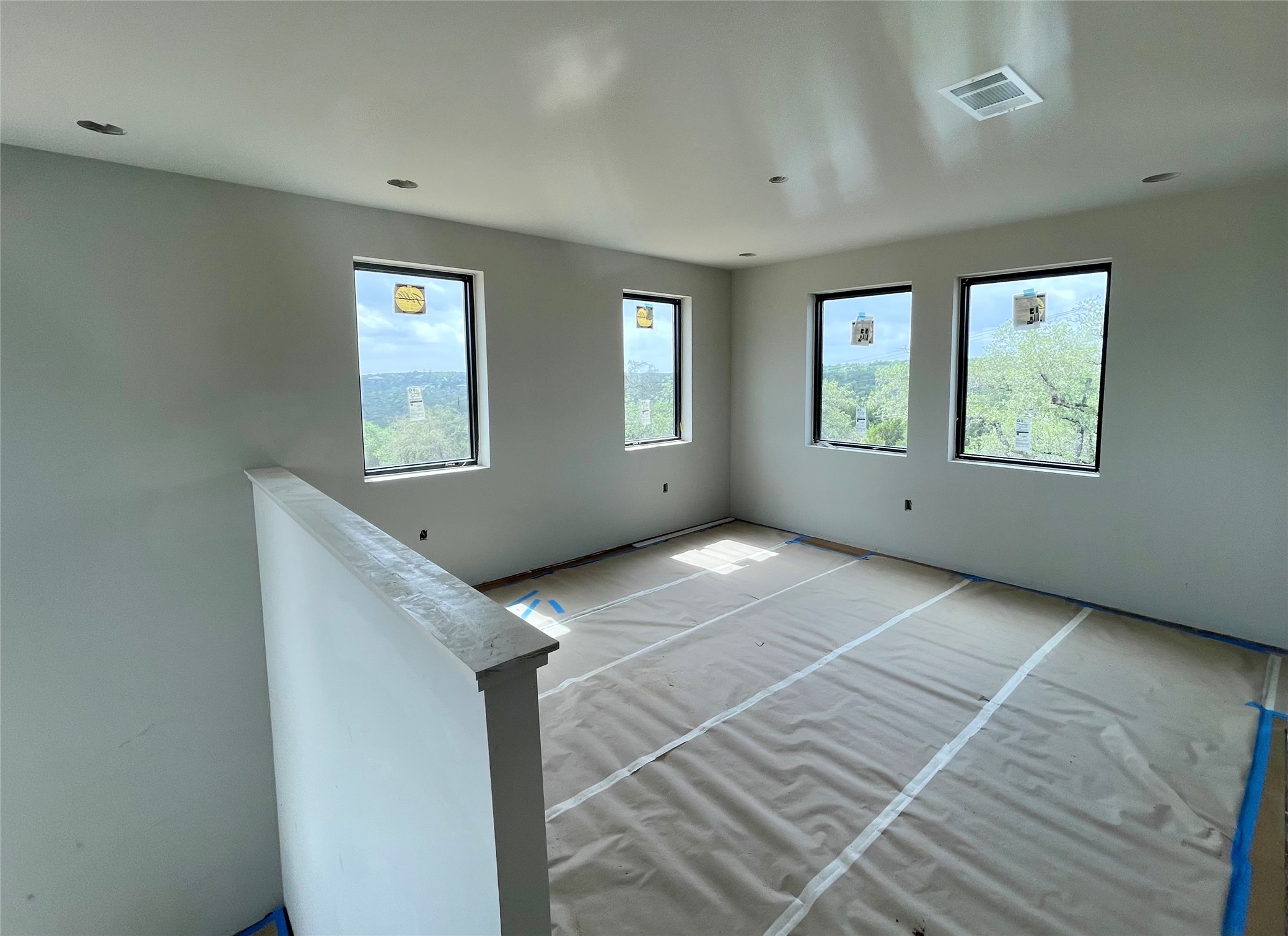 9803 Ribelin Ranch Court, Unit 21 Austin, TX 78750 - Photo 14 of 20 This room features four windows providing views of the surrounding trees and hills, recessed lighting, and an overhead ventilation system