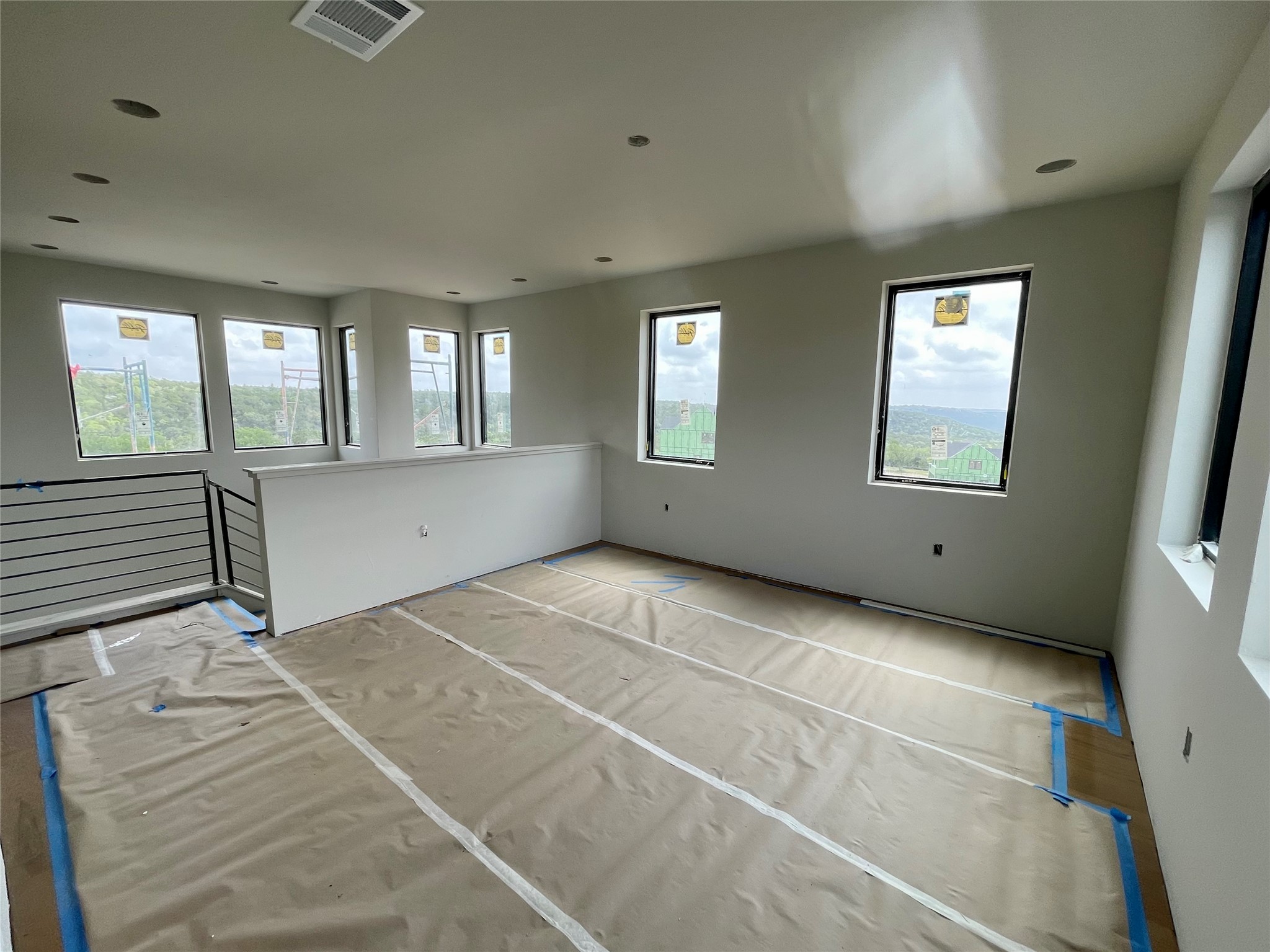 9803 Ribelin Ranch Court, Unit 21 Austin, TX 78750 - Photo 15 of 20 This open concept space features numerous windows providing abundant natural light and views, along with recessed lighting and a contemporary railing design