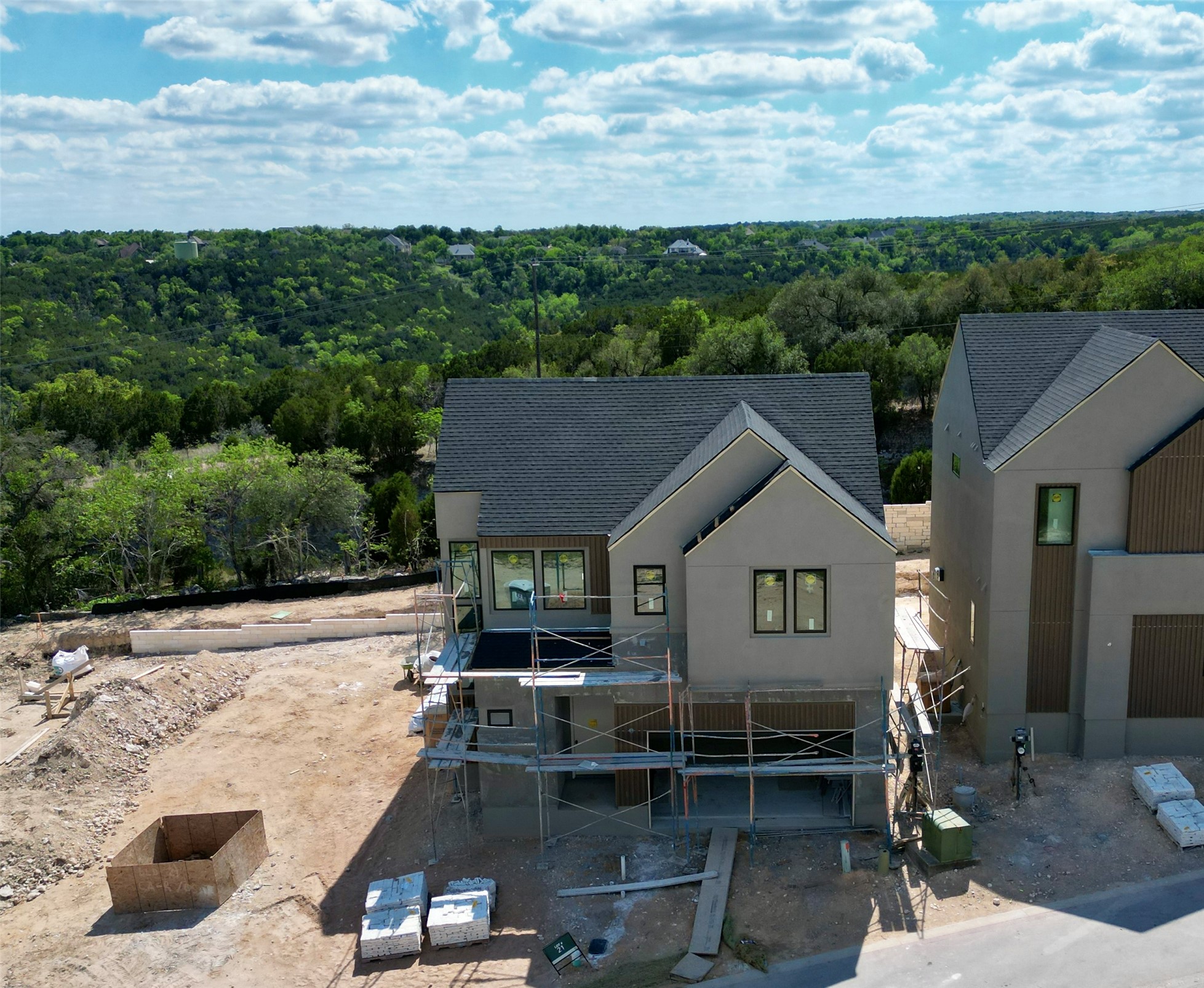 9803 Ribelin Ranch Court, Unit 21 Austin, TX 78750 - Photo 5 of 20 The property features a contemporary design with a dark grey roof and light-colored siding