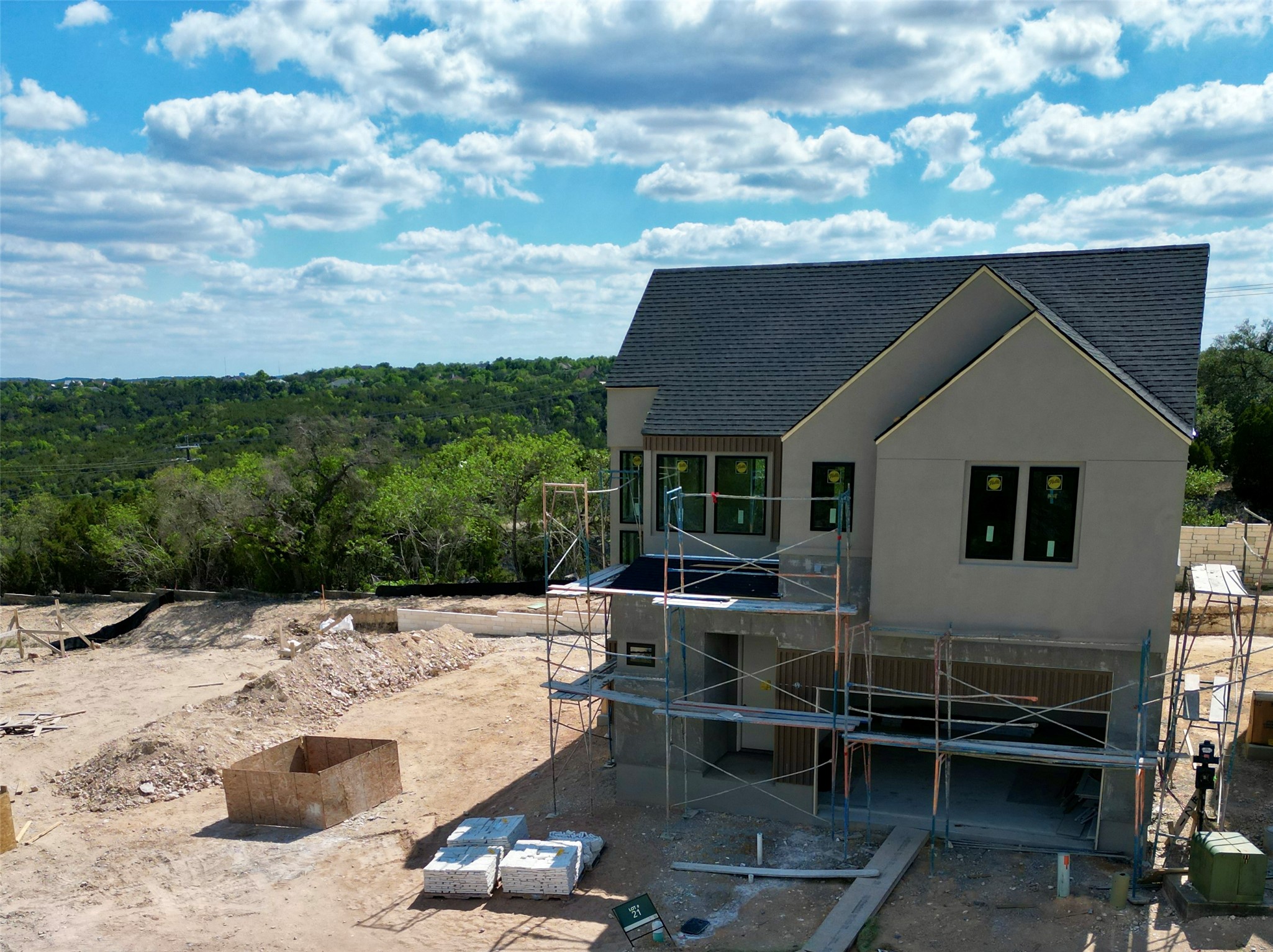 9803 Ribelin Ranch Court, Unit 21 Austin, TX 78750 - Photo 6 of 20 The property features a two-story design with a dark shingled roof and a light-colored stucco exterior
