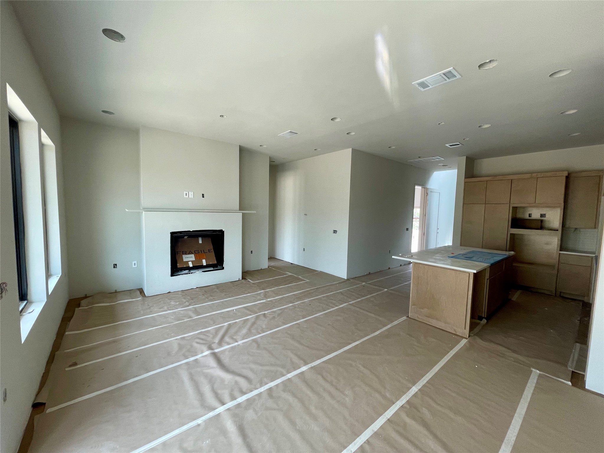 9803 Ribelin Ranch Court, Unit 21 Austin, TX 78750 - Photo 9 of 20 Living area featuring a fireplace with a mantel, recessed lighting, and large windows