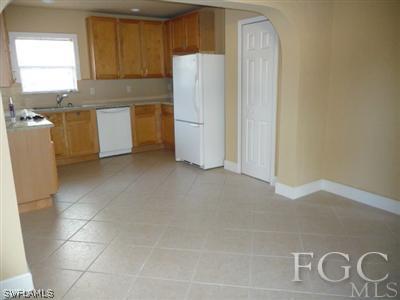 19095 Flamingo Road Fort Myers, FL 33967 - Photo 4 of 9 a kitchen with stainless steel appliances a refrigerator and a stove