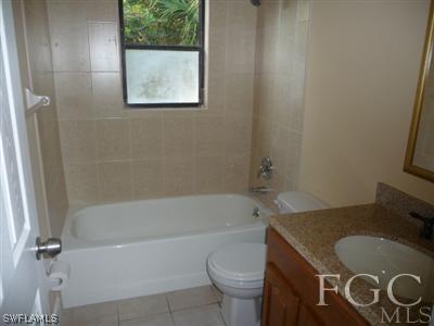 19095 Flamingo Road Fort Myers, FL 33967 - Photo 8 of 9 a bathroom with a sink and a mirror