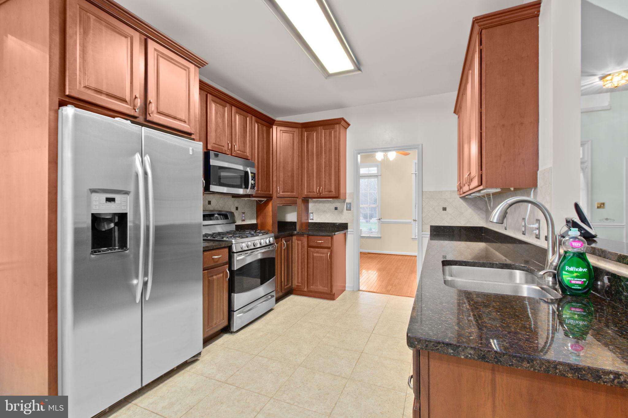 10721 Colbys Lane King George, VA 22485 - Photo 12 of 50 a kitchen with stainless steel appliances granite countertop a refrigerator a stove top oven a sink and dishwasher
