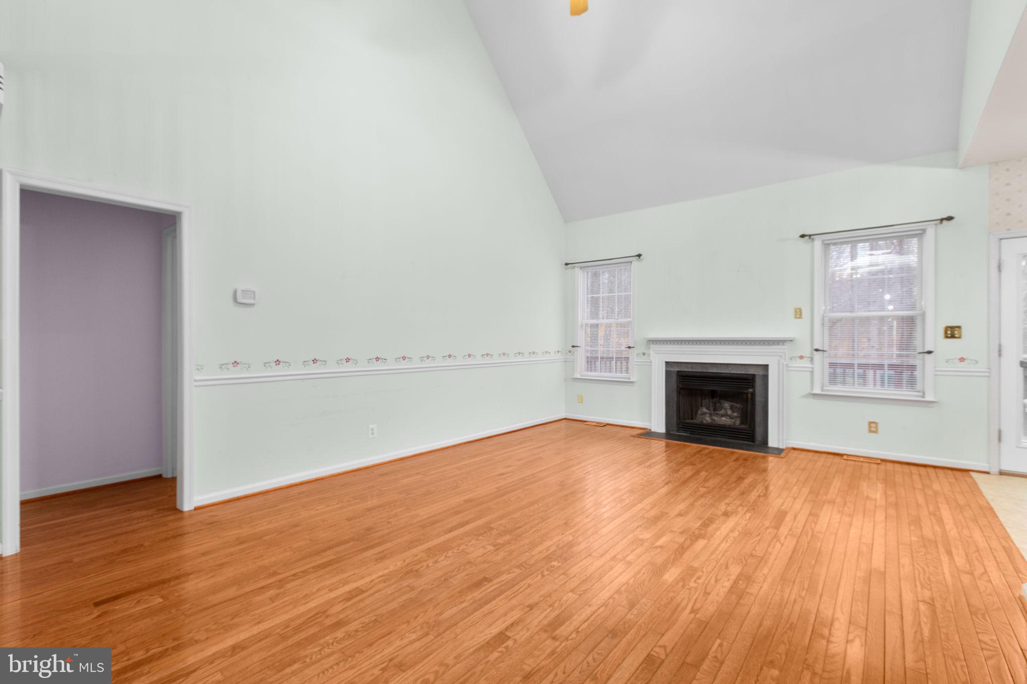 10721 Colbys Lane King George, VA 22485 - Photo 18 of 50 a view of empty room with wooden floor and fireplace