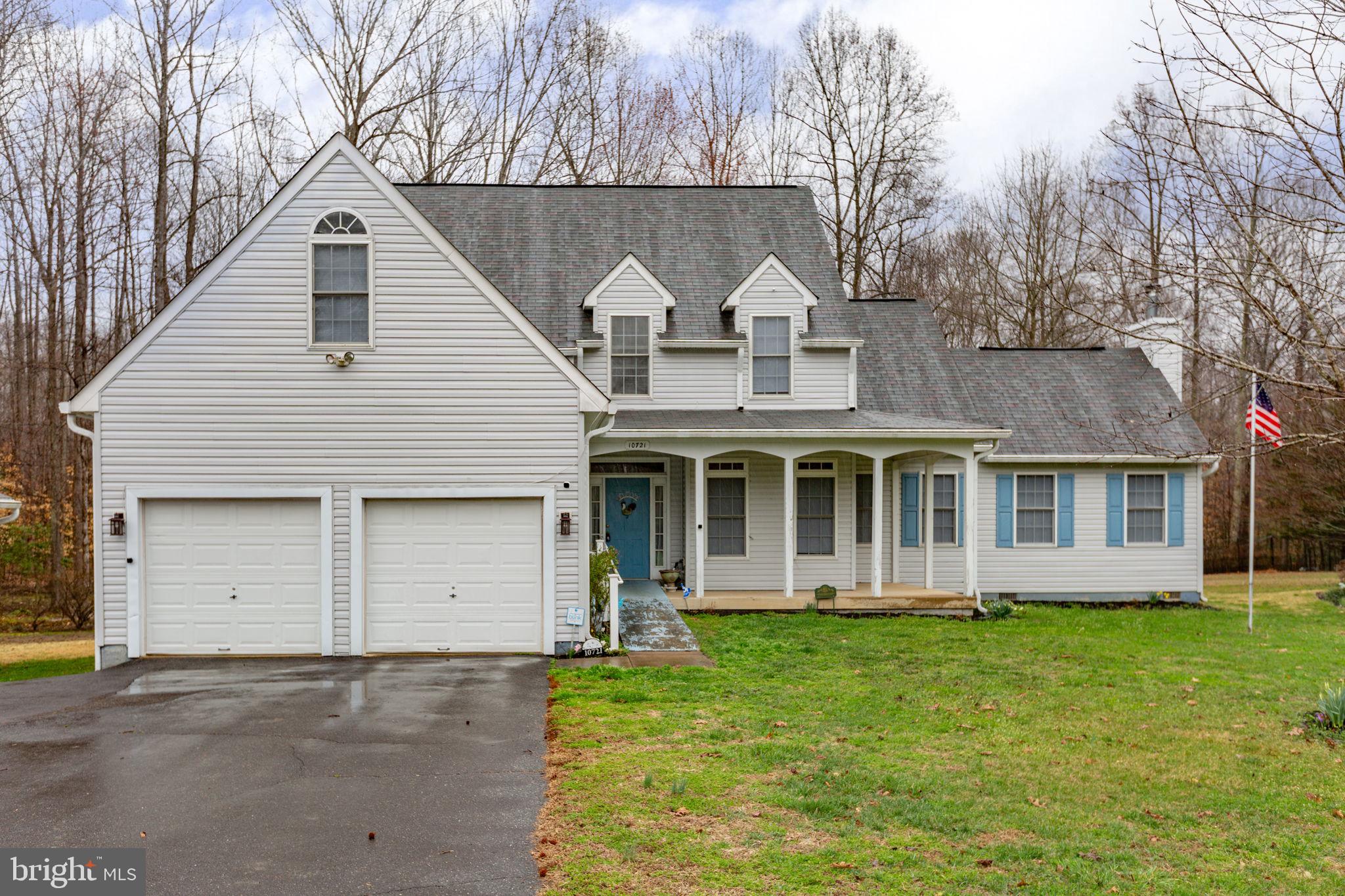 10721 Colbys Lane King George, VA 22485 - Photo 2 of 50 a view of a white house with large windows and a large tree with plants and large trees