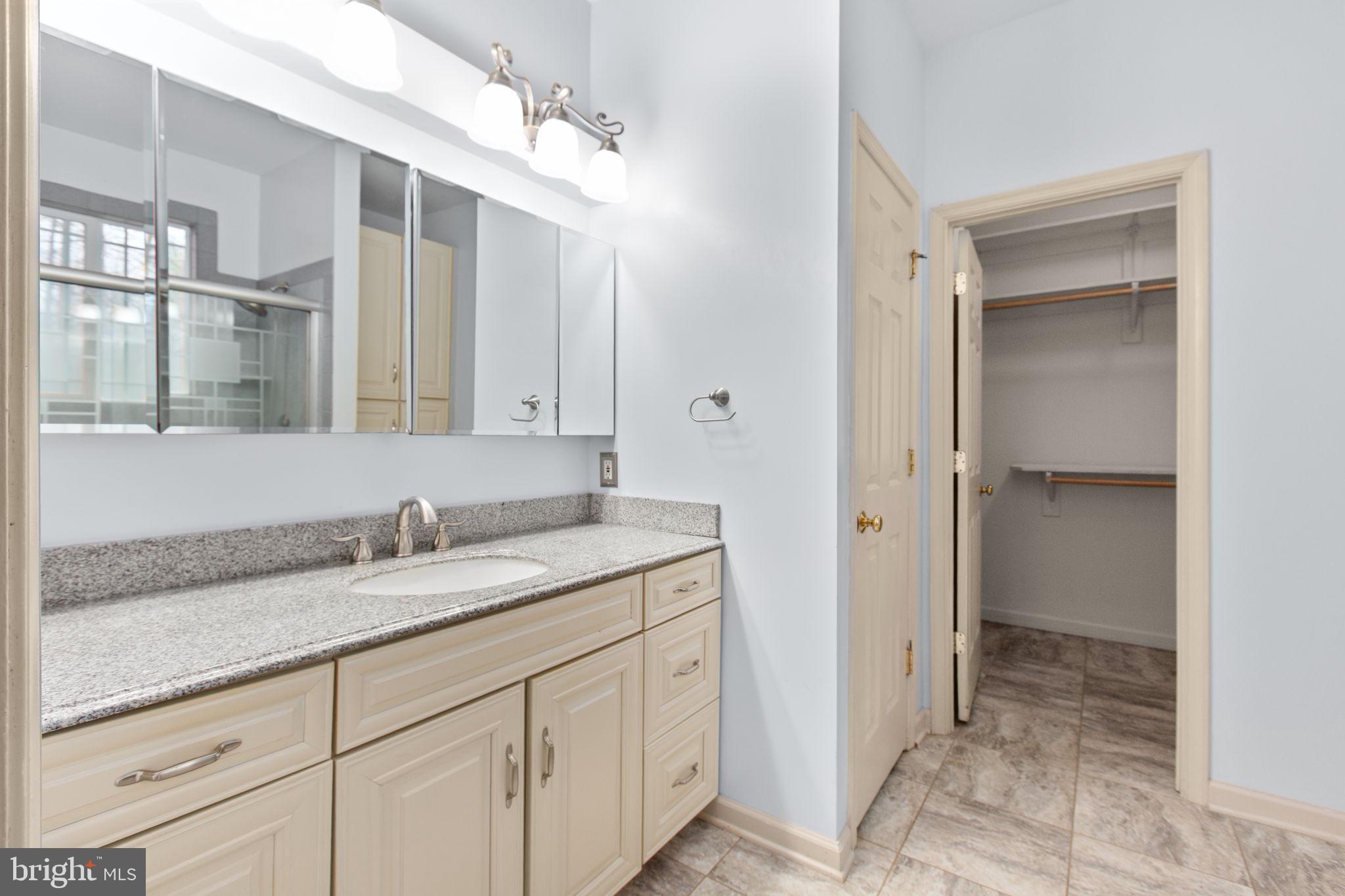 10721 Colbys Lane King George, VA 22485 - Photo 22 of 50 a bathroom with a granite countertop sink and a mirror