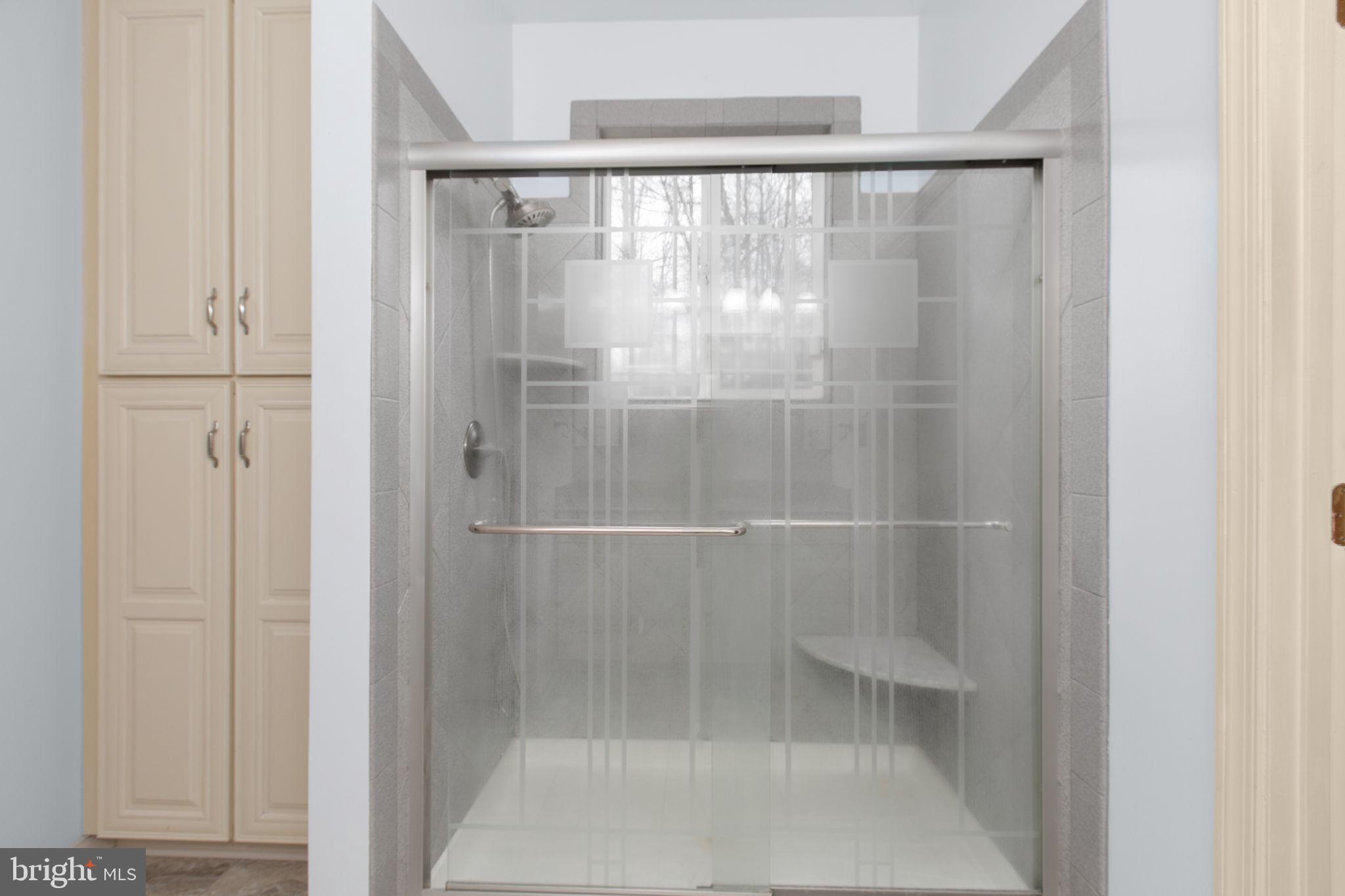 10721 Colbys Lane King George, VA 22485 - Photo 23 of 50 a bathroom with a glass shower door