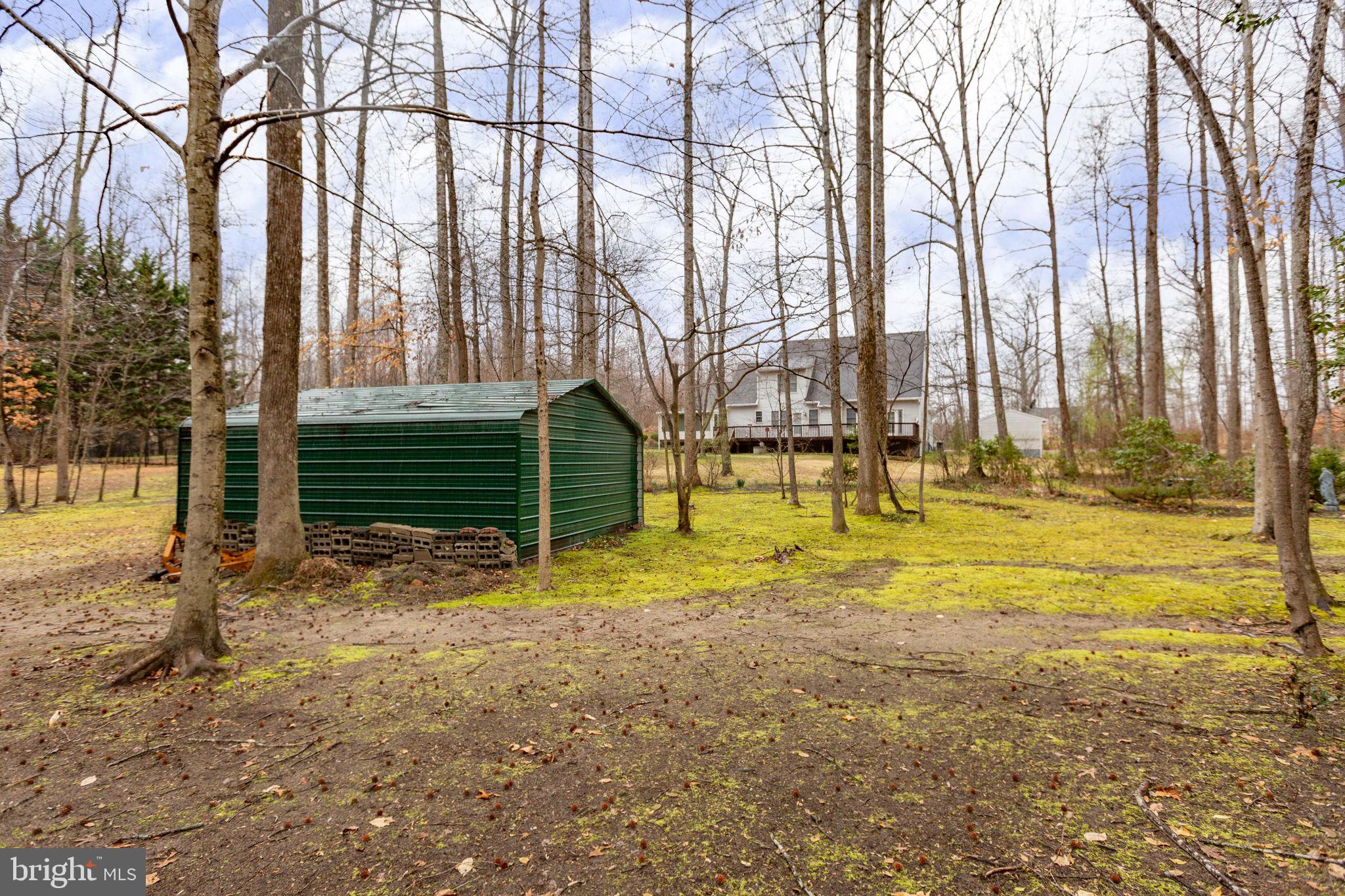 10721 Colbys Lane King George, VA 22485 - Photo 47 of 50 a view of swimming pool with large trees and wooden fence