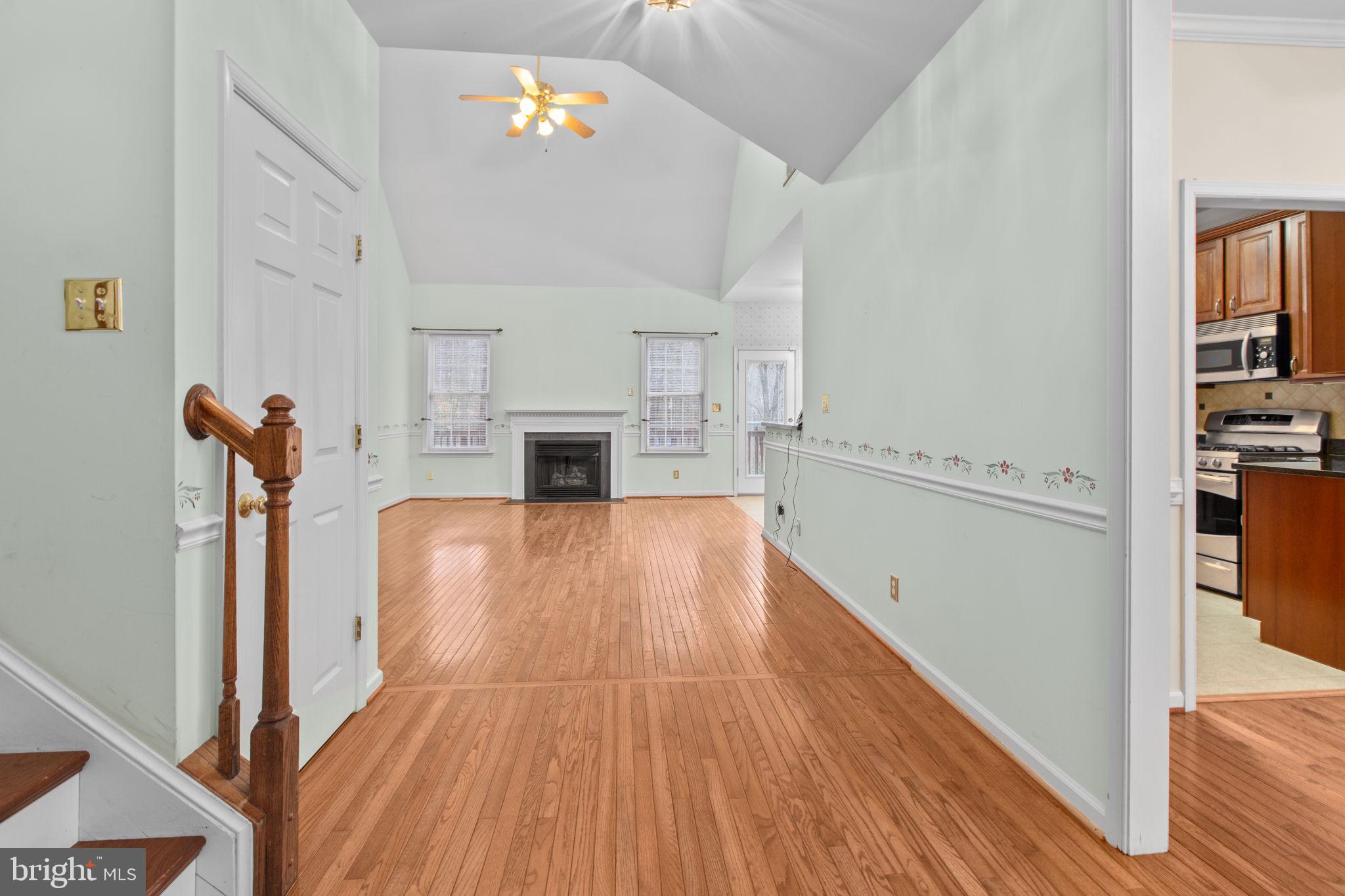 10721 Colbys Lane King George, VA 22485 - Photo 6 of 50 a view of empty room with a fireplace and wooden floor