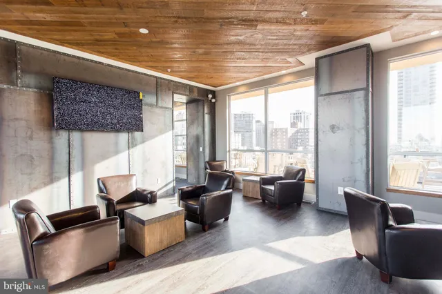 a living room with furniture and floor to ceiling windows