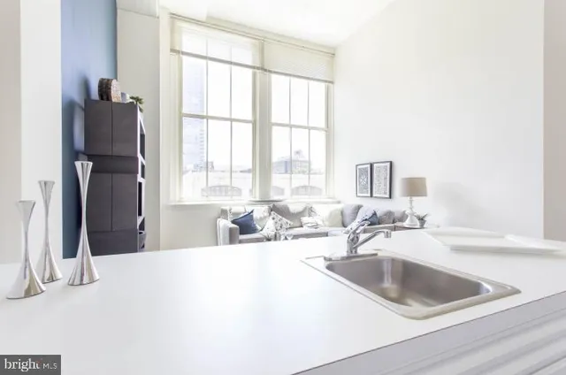 a kitchen with a sink cabinets and a large window
