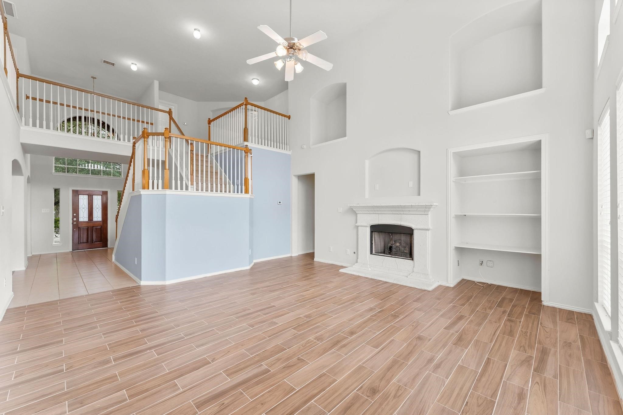 29902 Legends Ridge Drive Spring, TX 77386 - Photo 13 of 29 a view of a livingroom with wooden floor and a fireplace