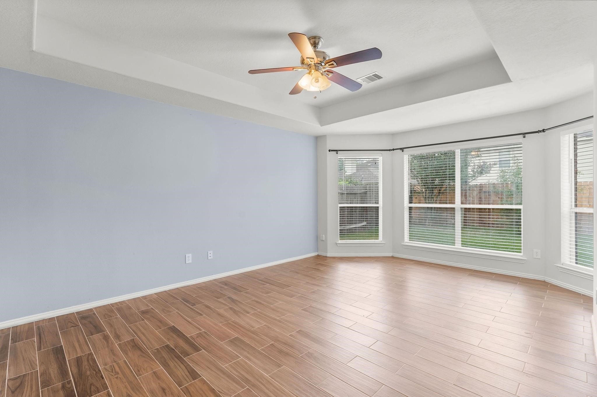 29902 Legends Ridge Drive Spring, TX 77386 - Photo 14 of 29 a view of an empty room with wooden floor and a window
