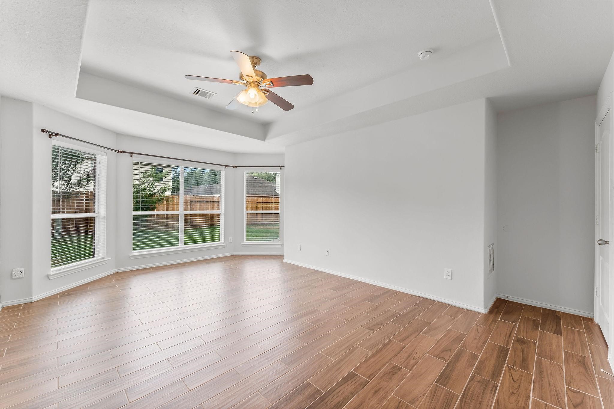 29902 Legends Ridge Drive Spring, TX 77386 - Photo 15 of 29 a view of an empty room with wooden floor and a window