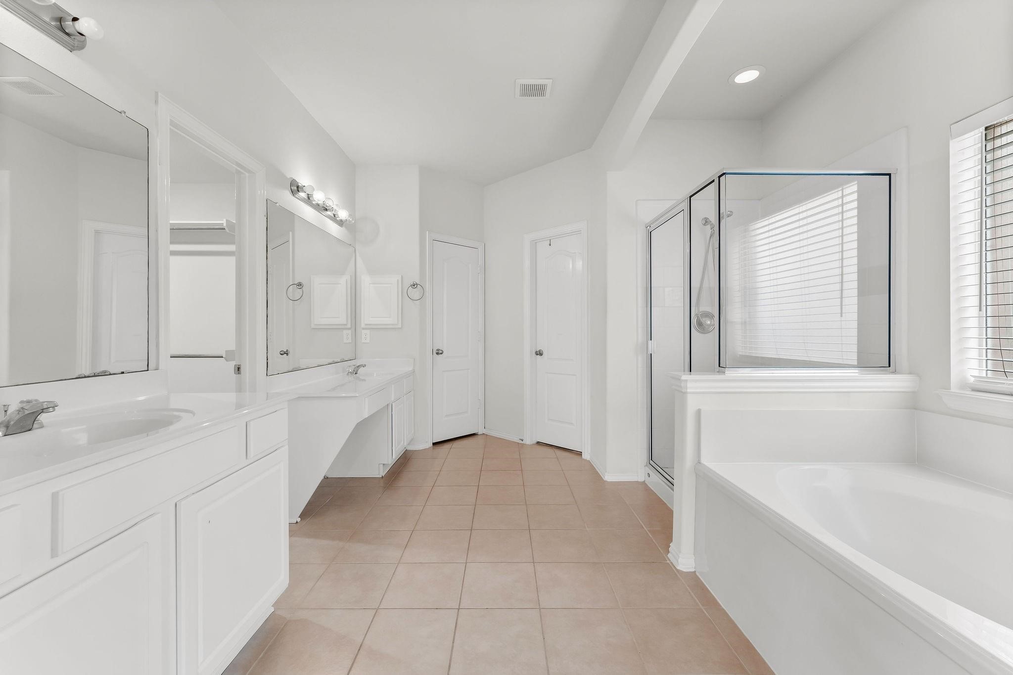 29902 Legends Ridge Drive Spring, TX 77386 - Photo 17 of 29 a spacious bathroom with a tub shower and sink