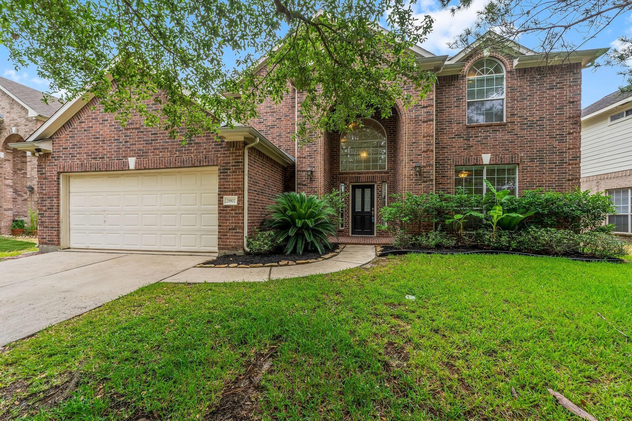 29902 Legends Ridge Drive Spring, TX 77386 - Photo 2 of 29 a front view of a house with a yard and garage