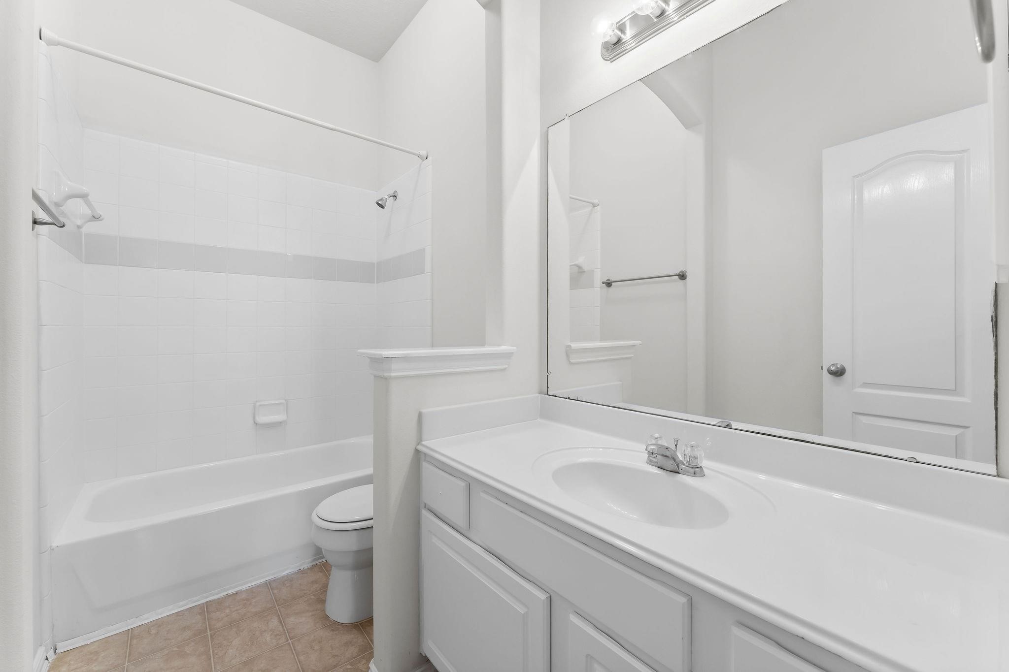29902 Legends Ridge Drive Spring, TX 77386 - Photo 22 of 29 a bathroom with a sink toilet vanity and tub