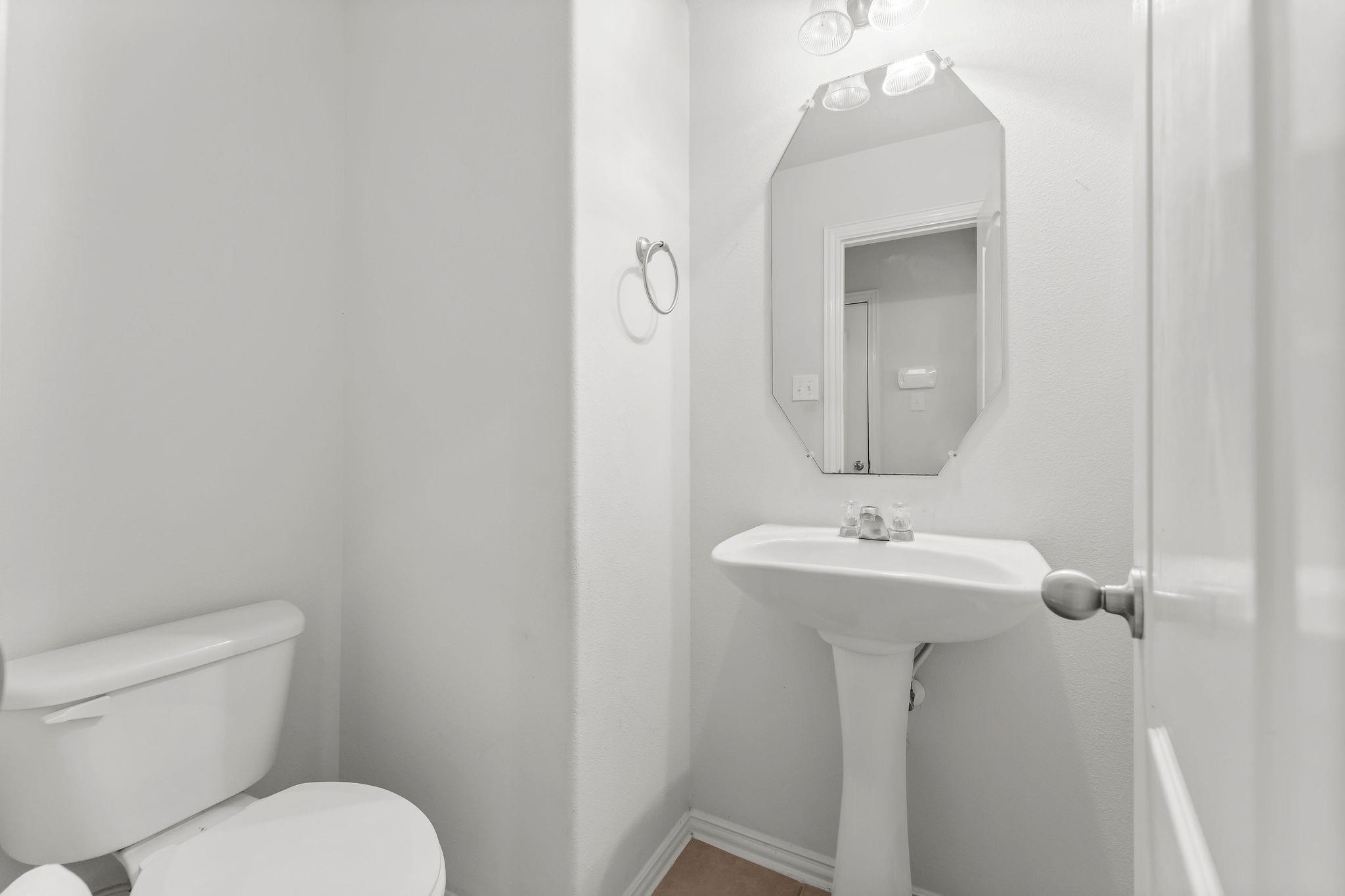 29902 Legends Ridge Drive Spring, TX 77386 - Photo 7 of 29 a bathroom with a toilet sink and mirror