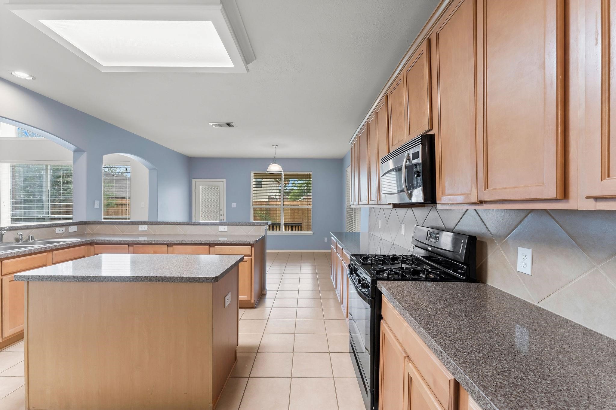 29902 Legends Ridge Drive Spring, TX 77386 - Photo 10 of 29 a kitchen with stainless steel appliances granite countertop a sink stove and cabinets