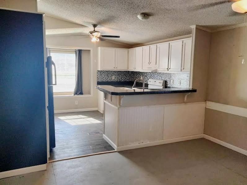 855 Tom Sawyer Road Ennis, TX 75119 - Photo 12 of 17 a kitchen with stainless steel appliances a sink stove and cabinets