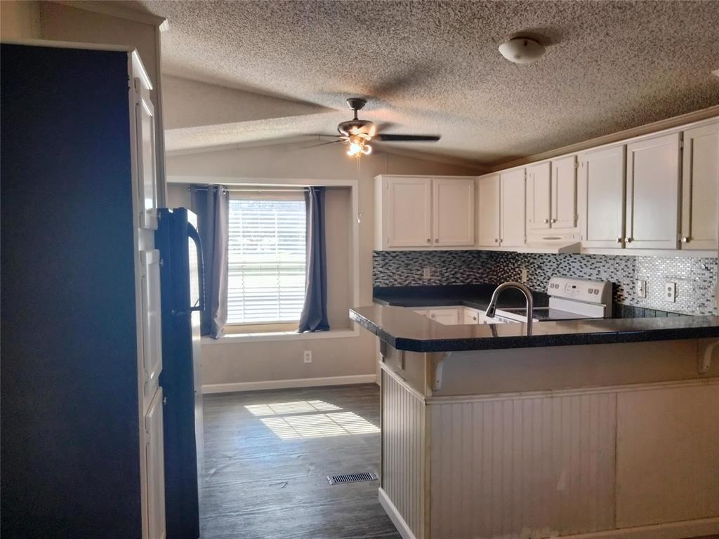 855 Tom Sawyer Road Ennis, TX 75119 - Photo 13 of 17 a kitchen with granite countertop a sink stainless steel appliances and cabinets