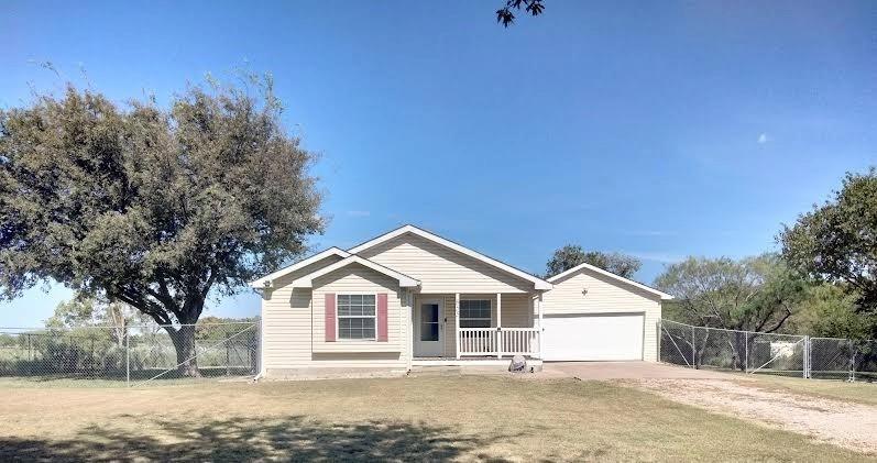 855 Tom Sawyer Road Ennis, TX 75119 - Photo 2 of 17 a front view of a house with a yard