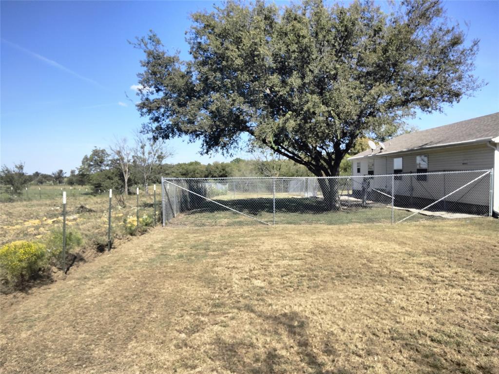 855 Tom Sawyer Road Ennis, TX 75119 - Photo 3 of 17 a view of a yard with wooden fence