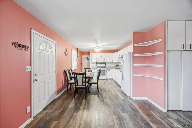 a dining room with furniture and wooden floor