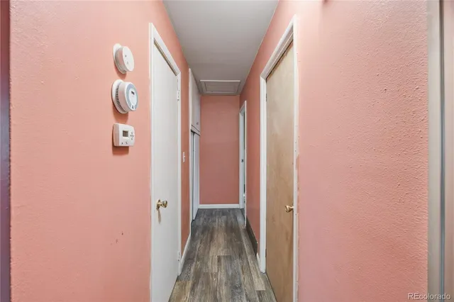a view of a hallway with wooden floor and glass door