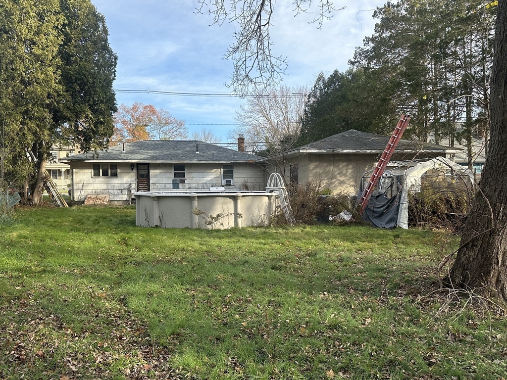 345 Chace Street Somerset, MA 02726 - Photo 15 of 18 a backyard of a house with large trees and barbeque oven