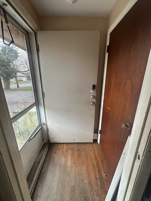 345 Chace Street Somerset, MA 02726 - Photo 3 of 18 an empty room with wooden floor and door