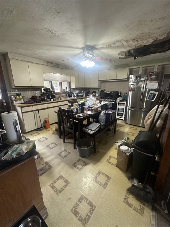 345 Chace Street Somerset, MA 02726 - Photo 5 of 18 a living room with lots of furniture and clutter