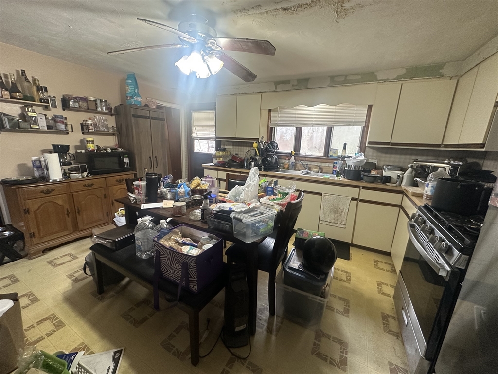 345 Chace Street Somerset, MA 02726 - Photo 7 of 18 a kitchen with a table chairs stove and refrigerator