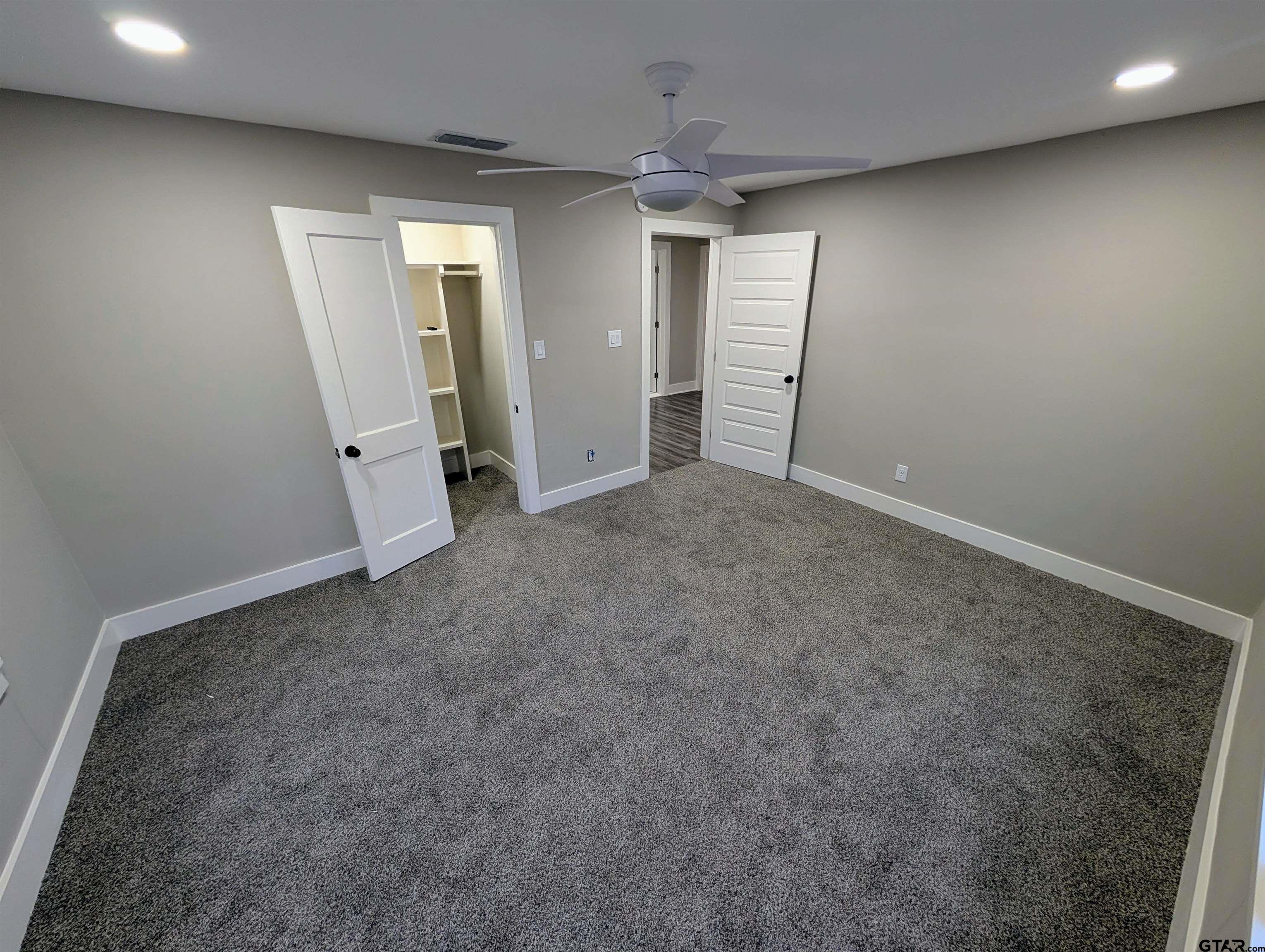 1213 Academy Street Tyler, TX 75701 - Photo 29 of 41 an empty room with staircase and mirror