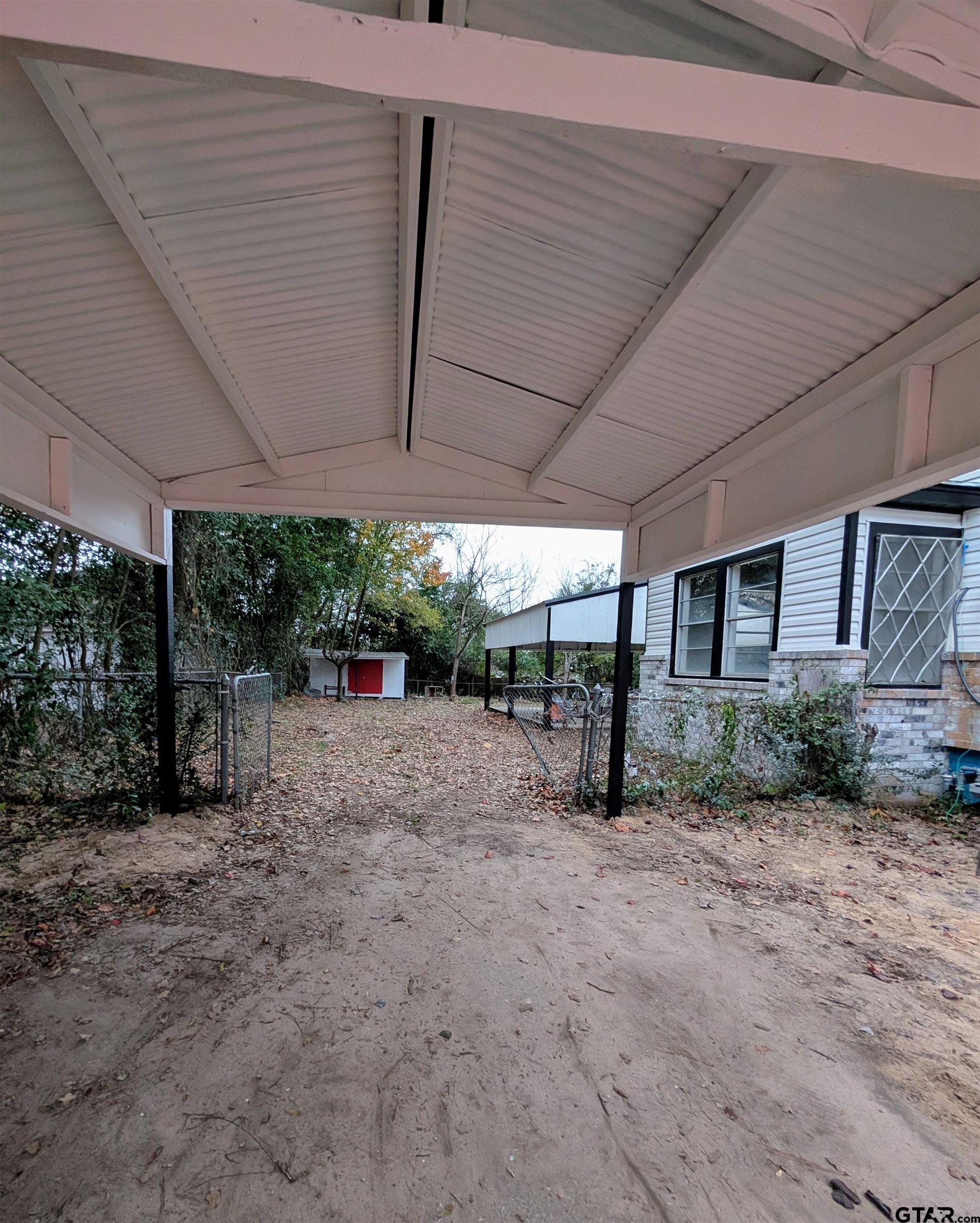 1213 Academy Street Tyler, TX 75701 - Photo 32 of 41 a view of a backyard with plants and large trees