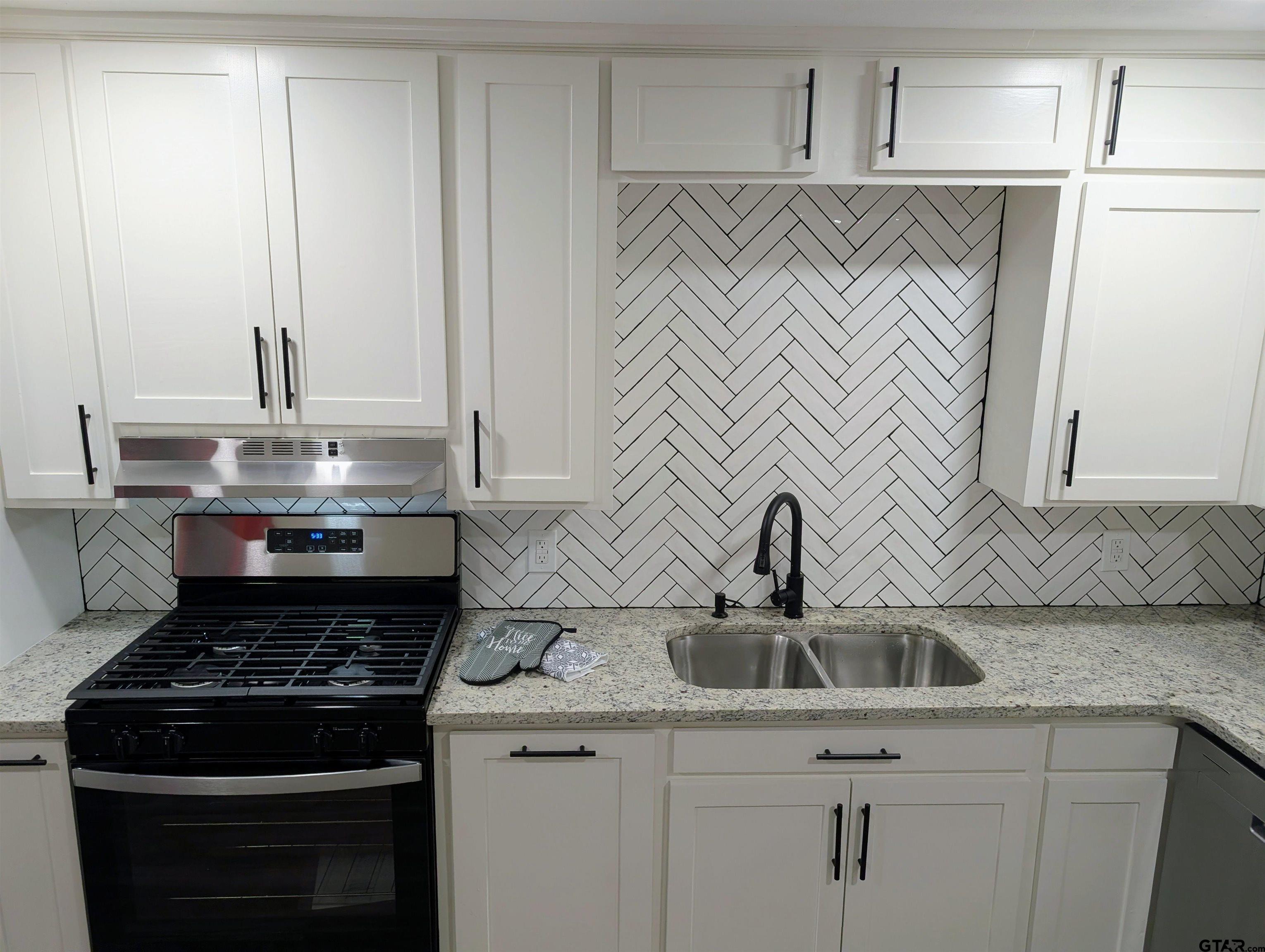 1213 Academy Street Tyler, TX 75701 - Photo 5 of 41 a stove top oven sitting inside of a kitchen