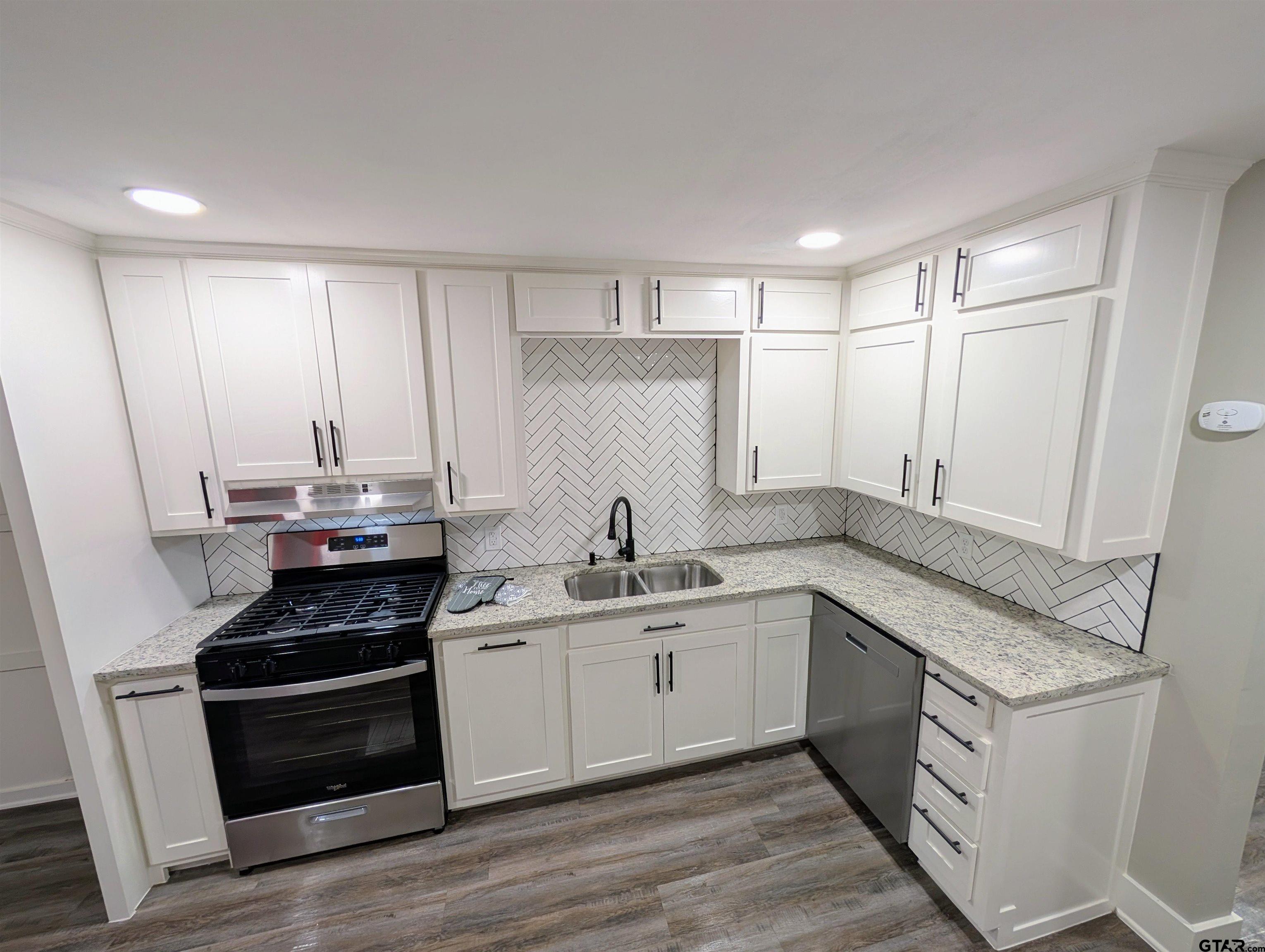 1213 Academy Street Tyler, TX 75701 - Photo 6 of 41 a kitchen with a sink stove and cabinets