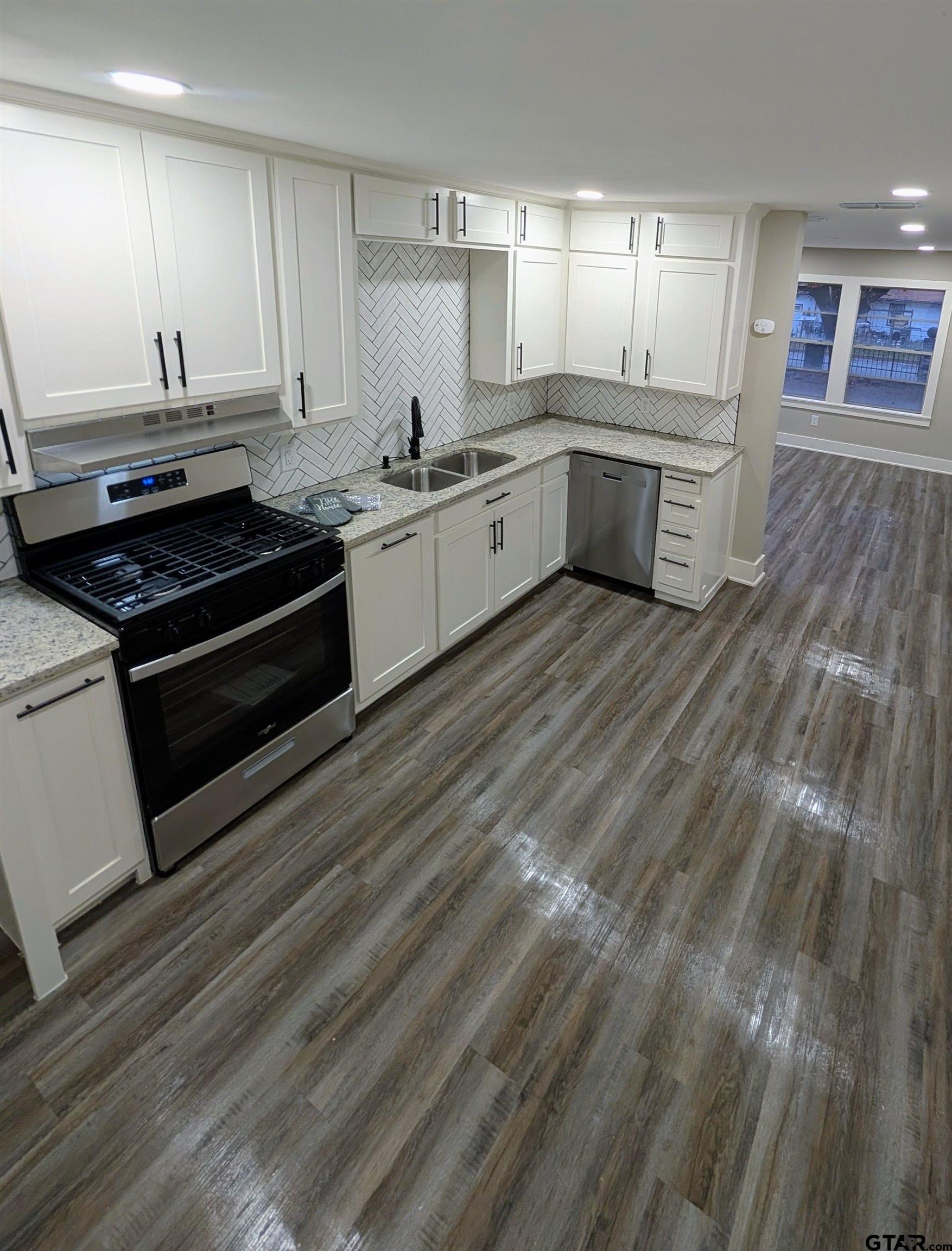 1213 Academy Street Tyler, TX 75701 - Photo 8 of 41 a kitchen with a sink stove and cabinets