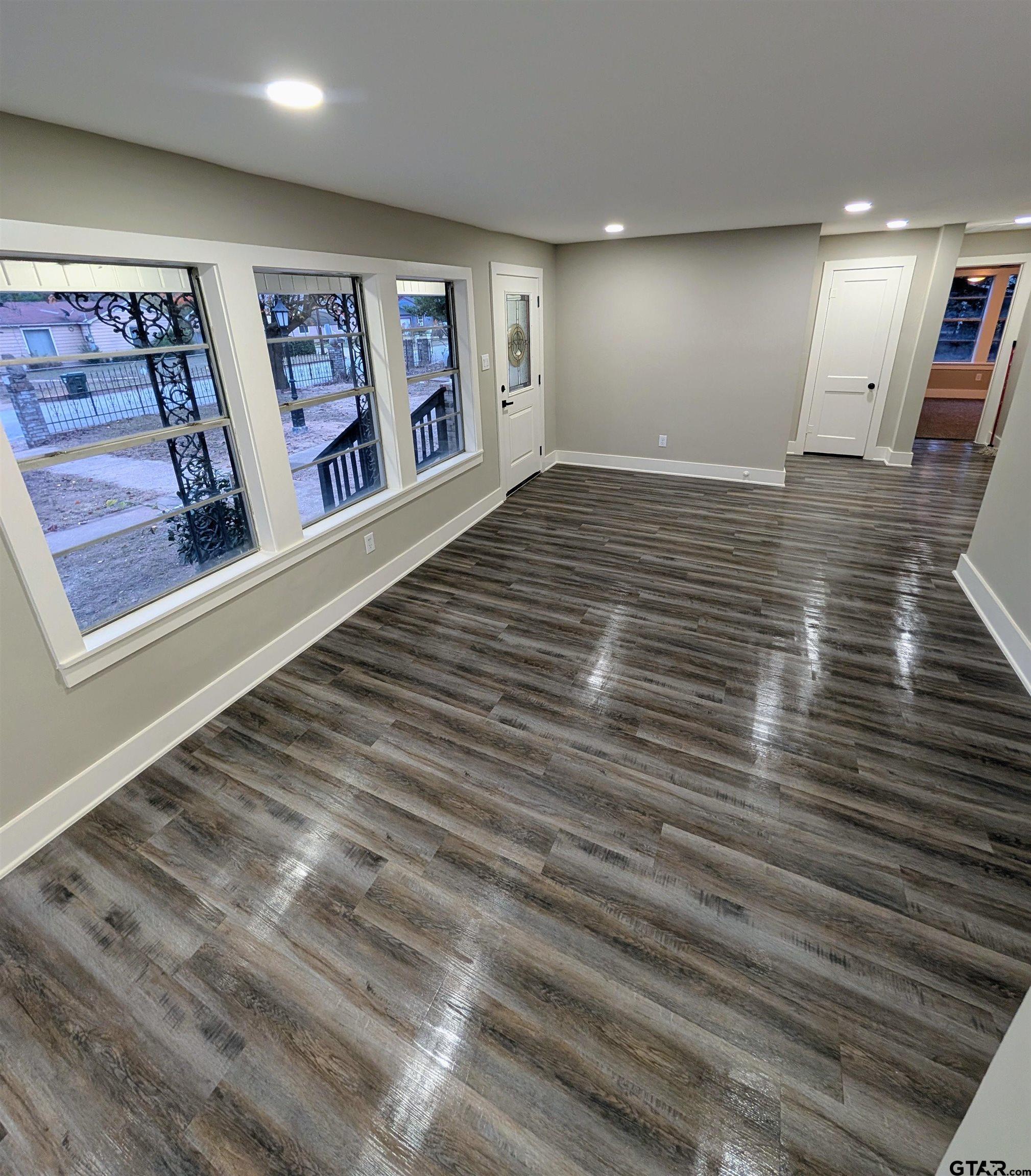 1213 Academy Street Tyler, TX 75701 - Photo 10 of 41 a view of a hallway with paintings on the wall